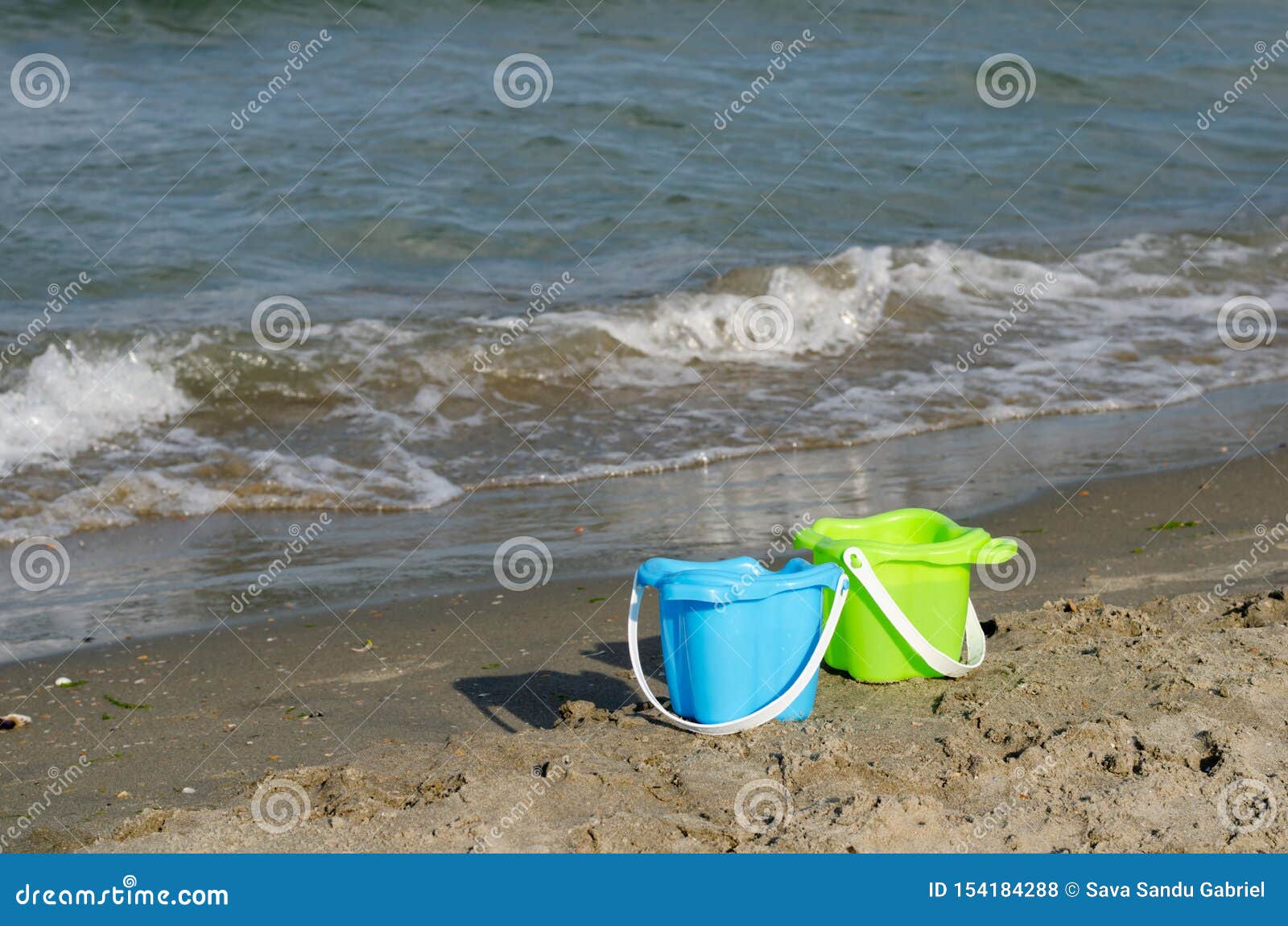 Plastic Buckets for Children for Playing on the Beach Stock Photo