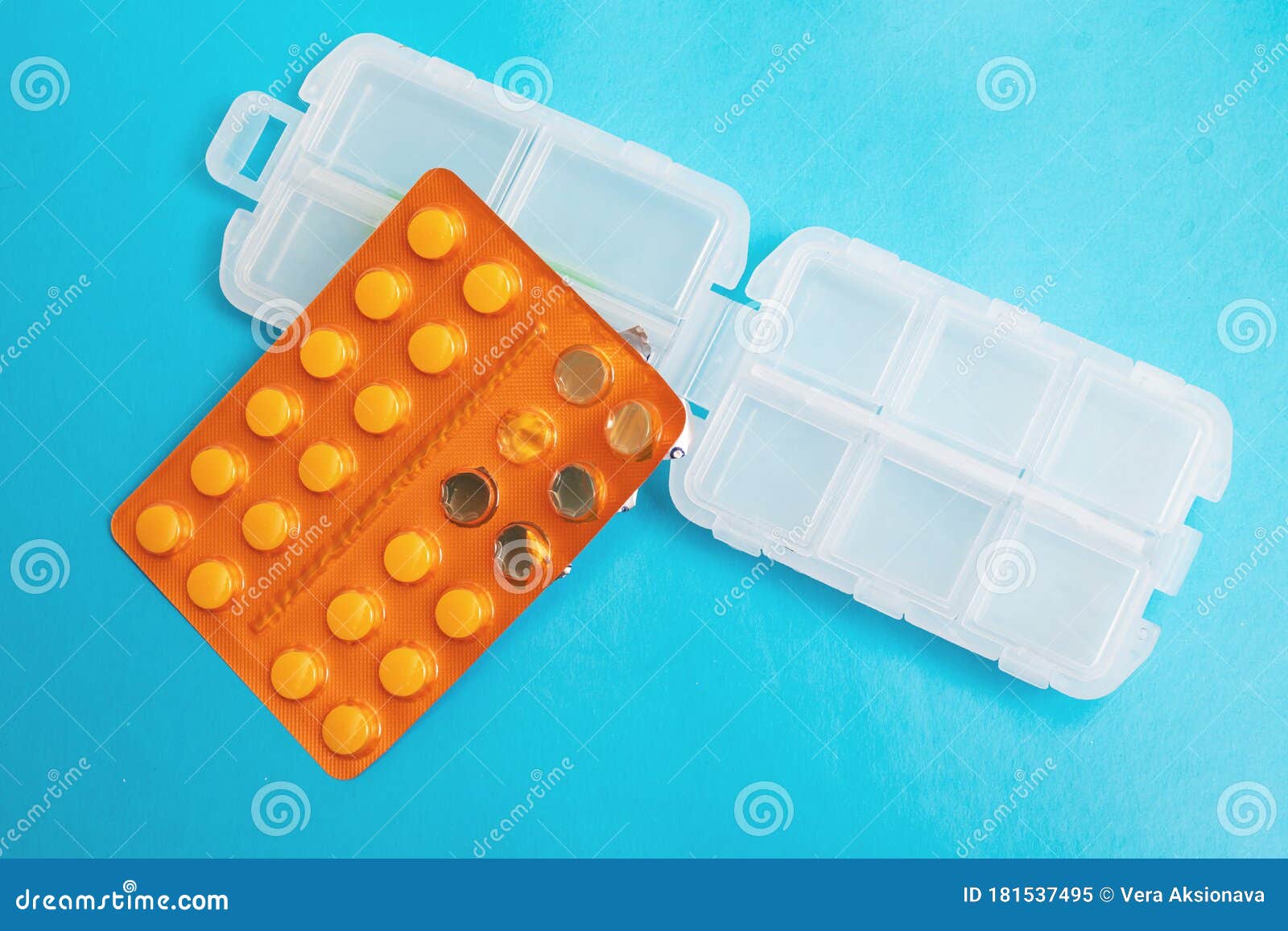 Plastic Container for Pills and Pills Pack on Blue Background Stock
