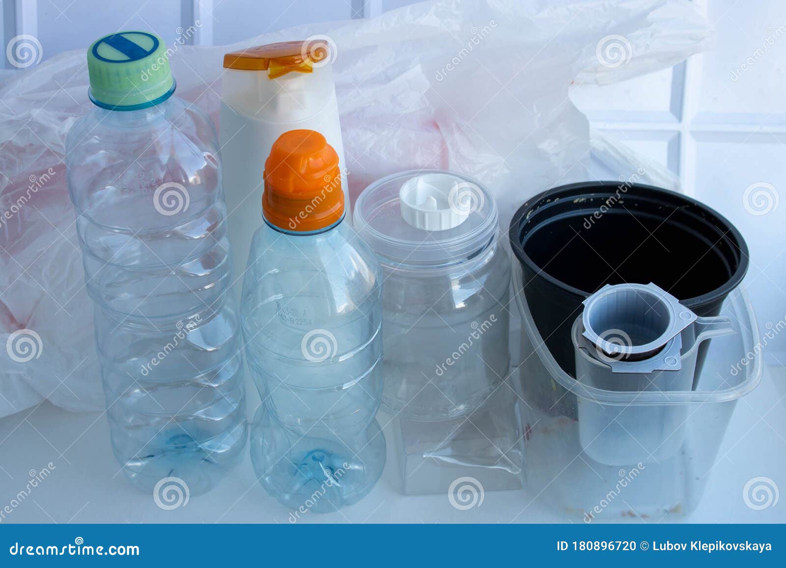 Plastic Containers on a White Background. the Processing of Plastics