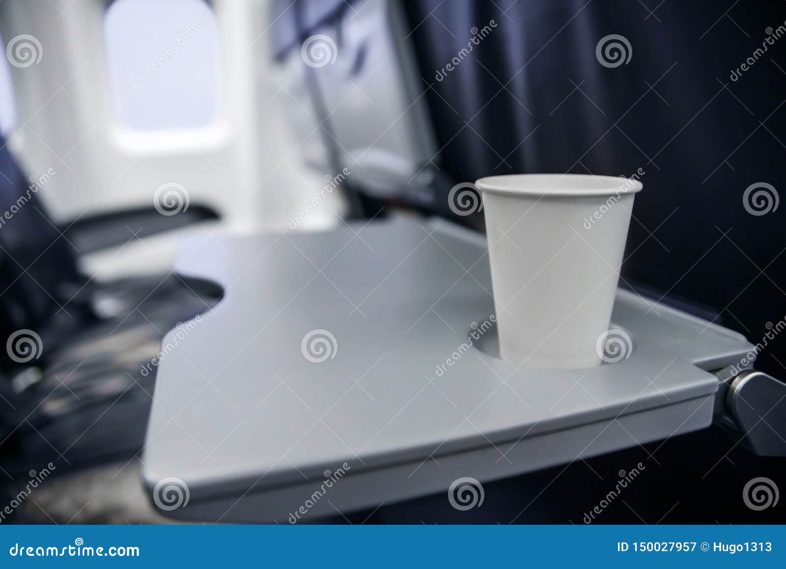 Plastic Cup on the Table in the Plane during the Flight. Alcohol