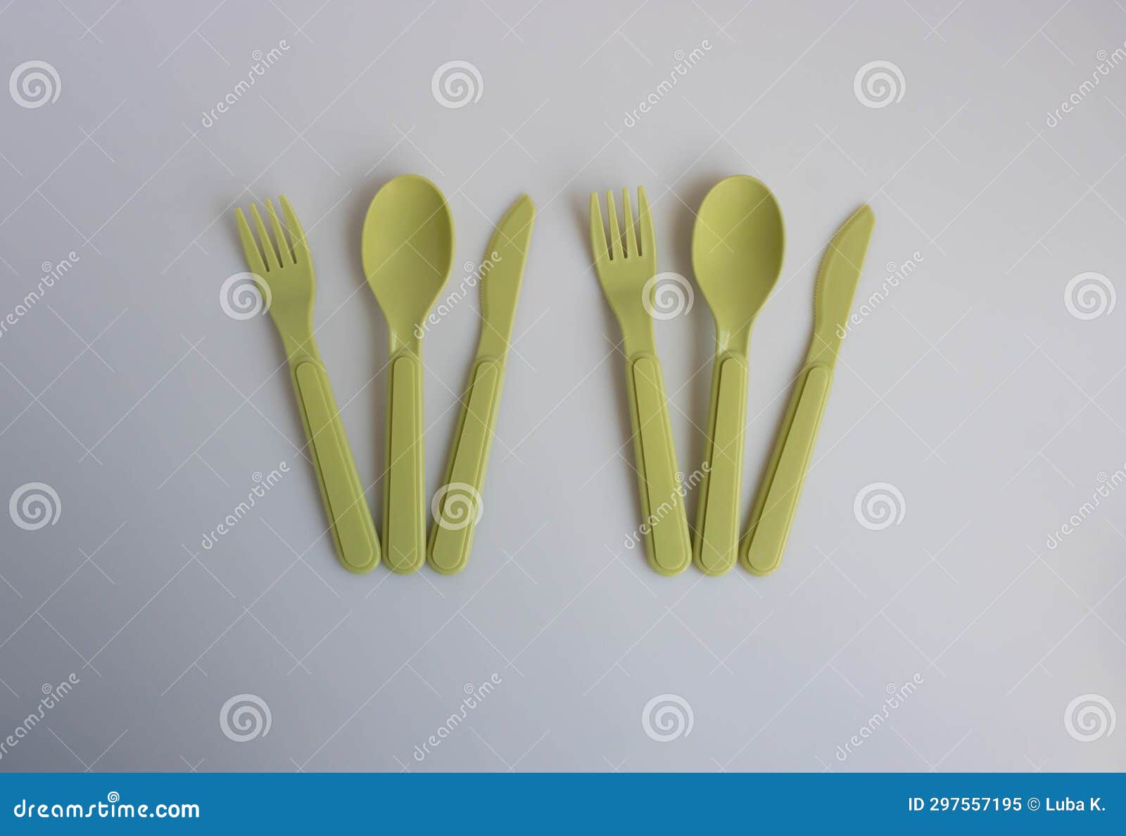 Plastic Fork, Spoon and Olivecolored Knife are on the Table Stock