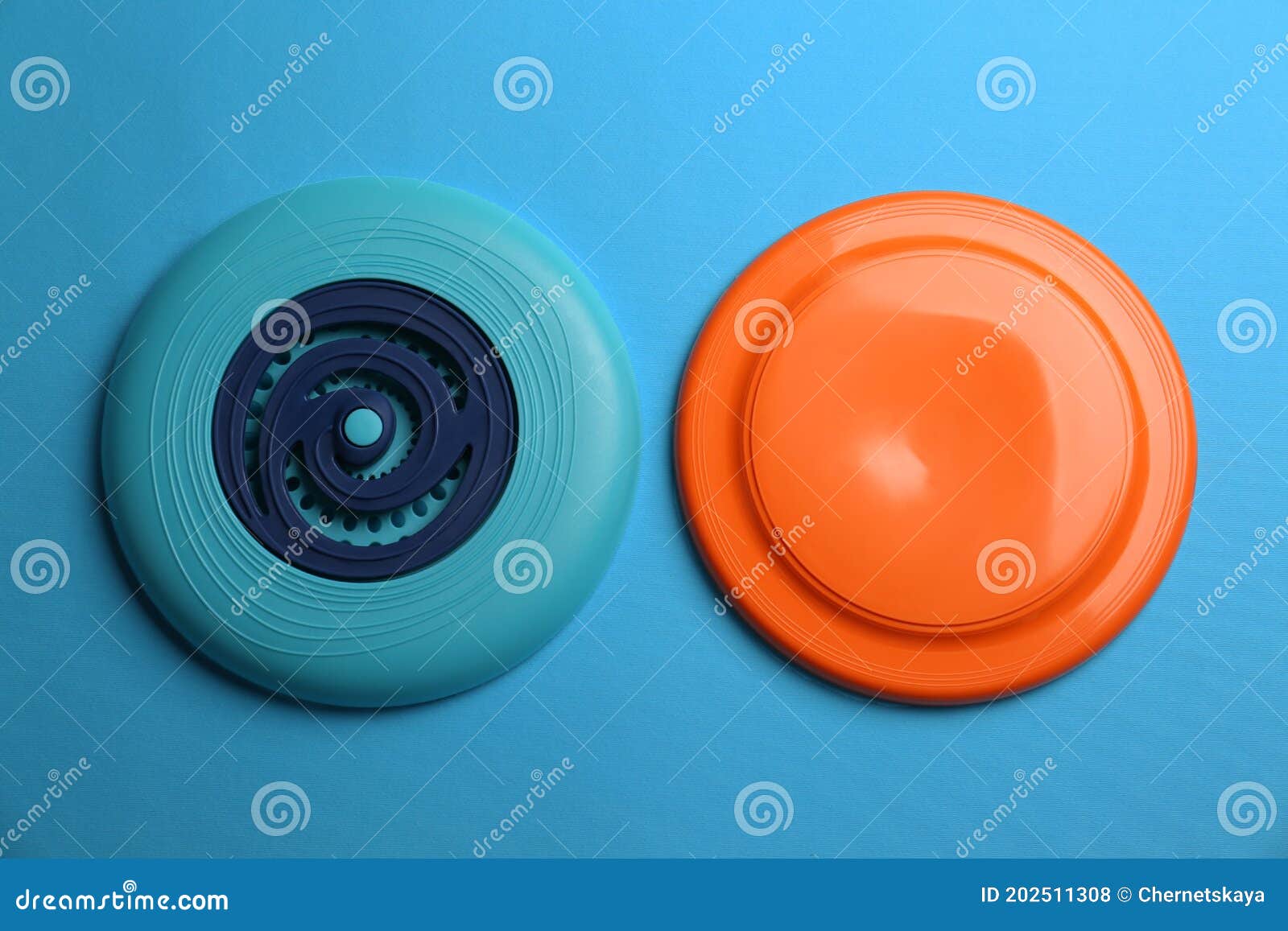 Plastic Frisbee Disks on Light Blue Background, Flat Lay Stock Photo