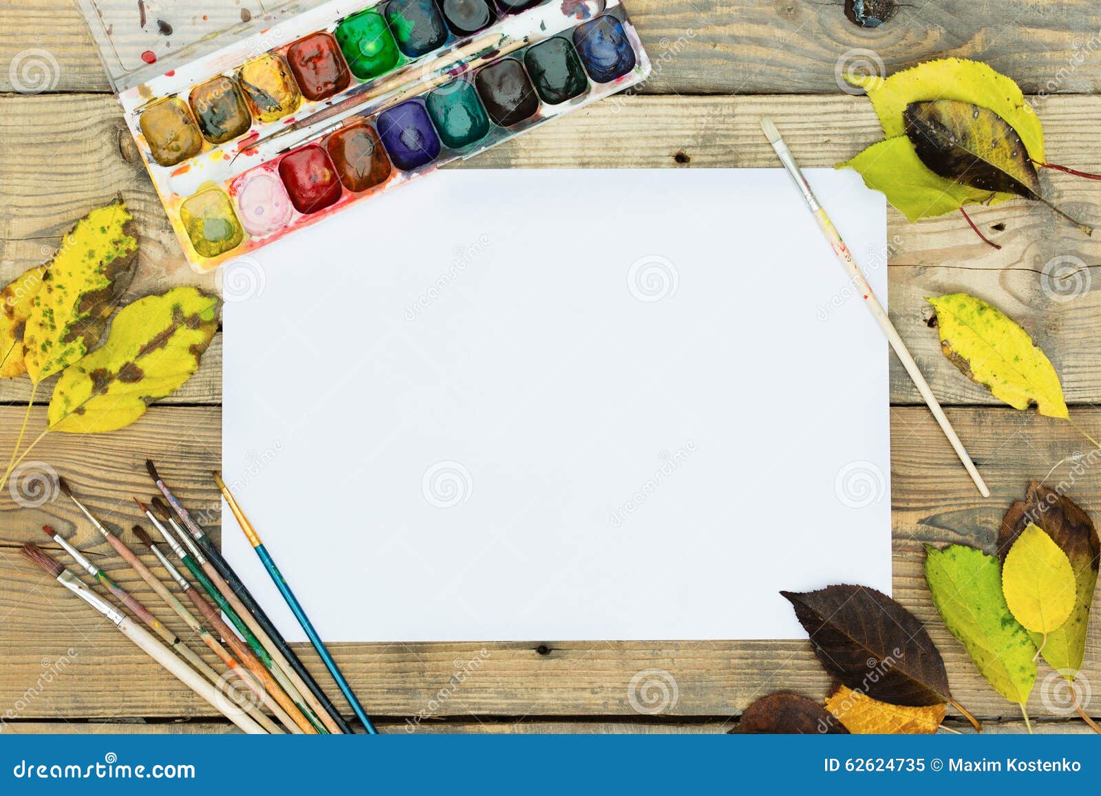 Plastic Paint Palette with Paint and Brushes on Wood Stock Image