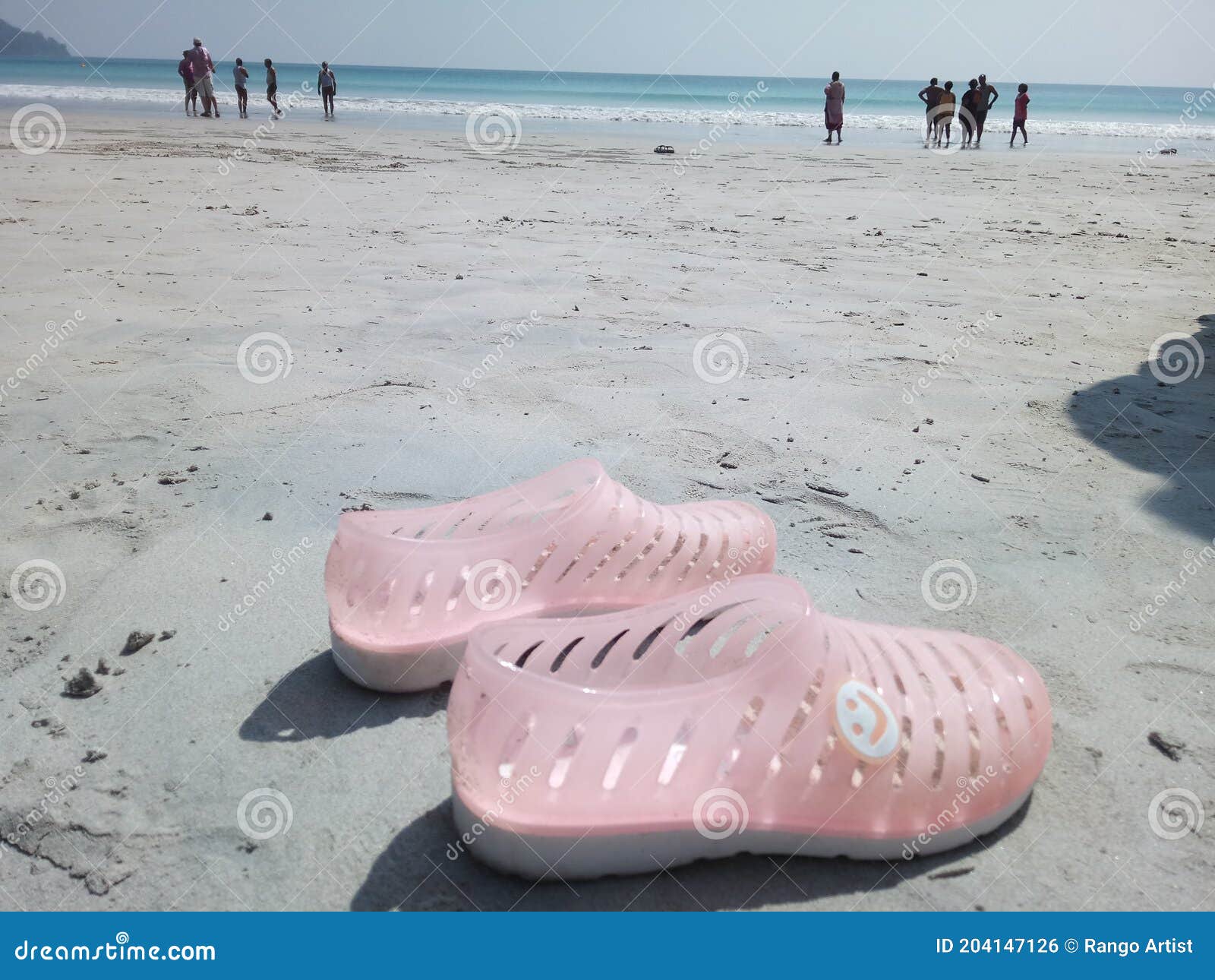 Plastic shoes at beach stock photo. Image of ocean, vacation 204147126