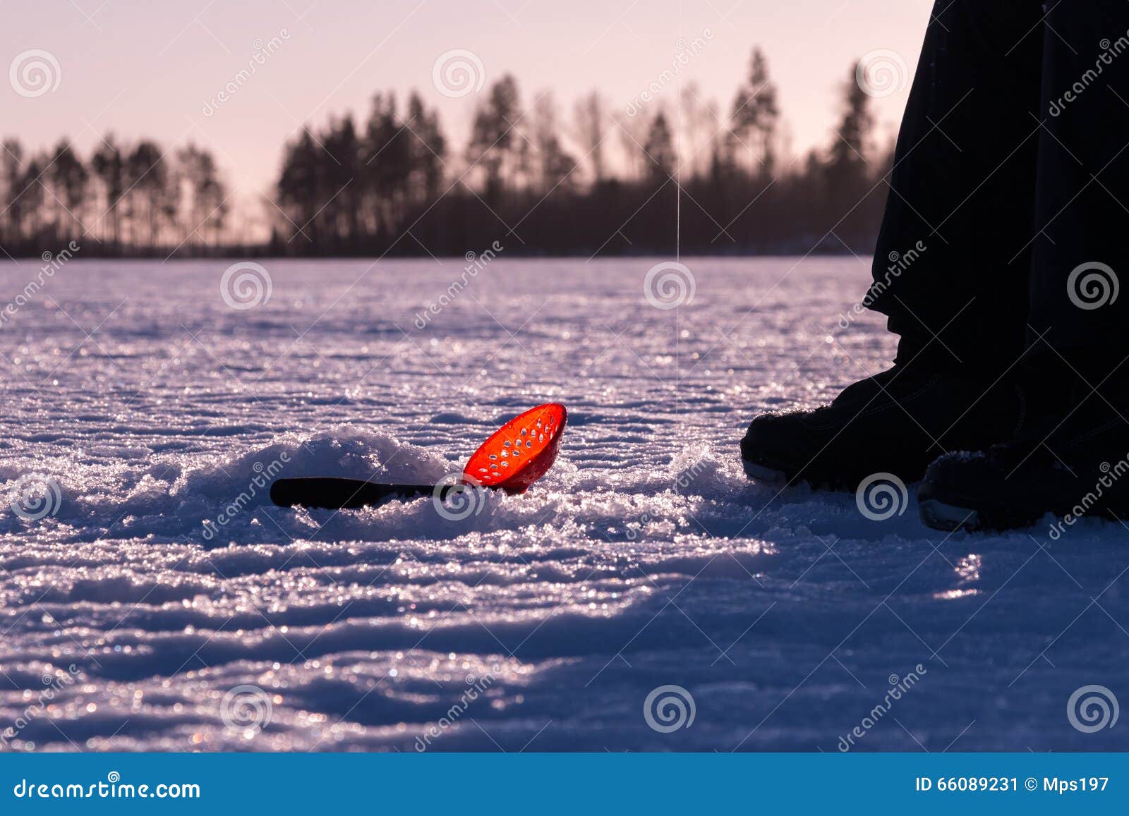 Plastic Skimmer Scoop Laying on Ice while Ice Fishing Stock Image