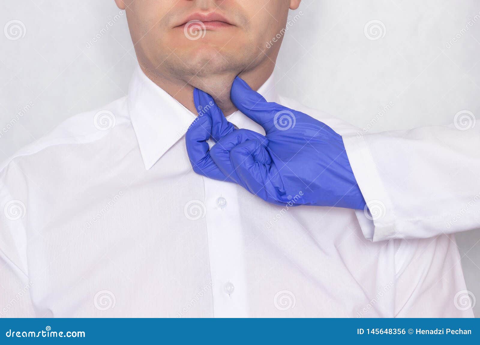 plastic surgeon doctor prepares a young caucasian man for a double chin fat surgery, thyroid gland, portrait