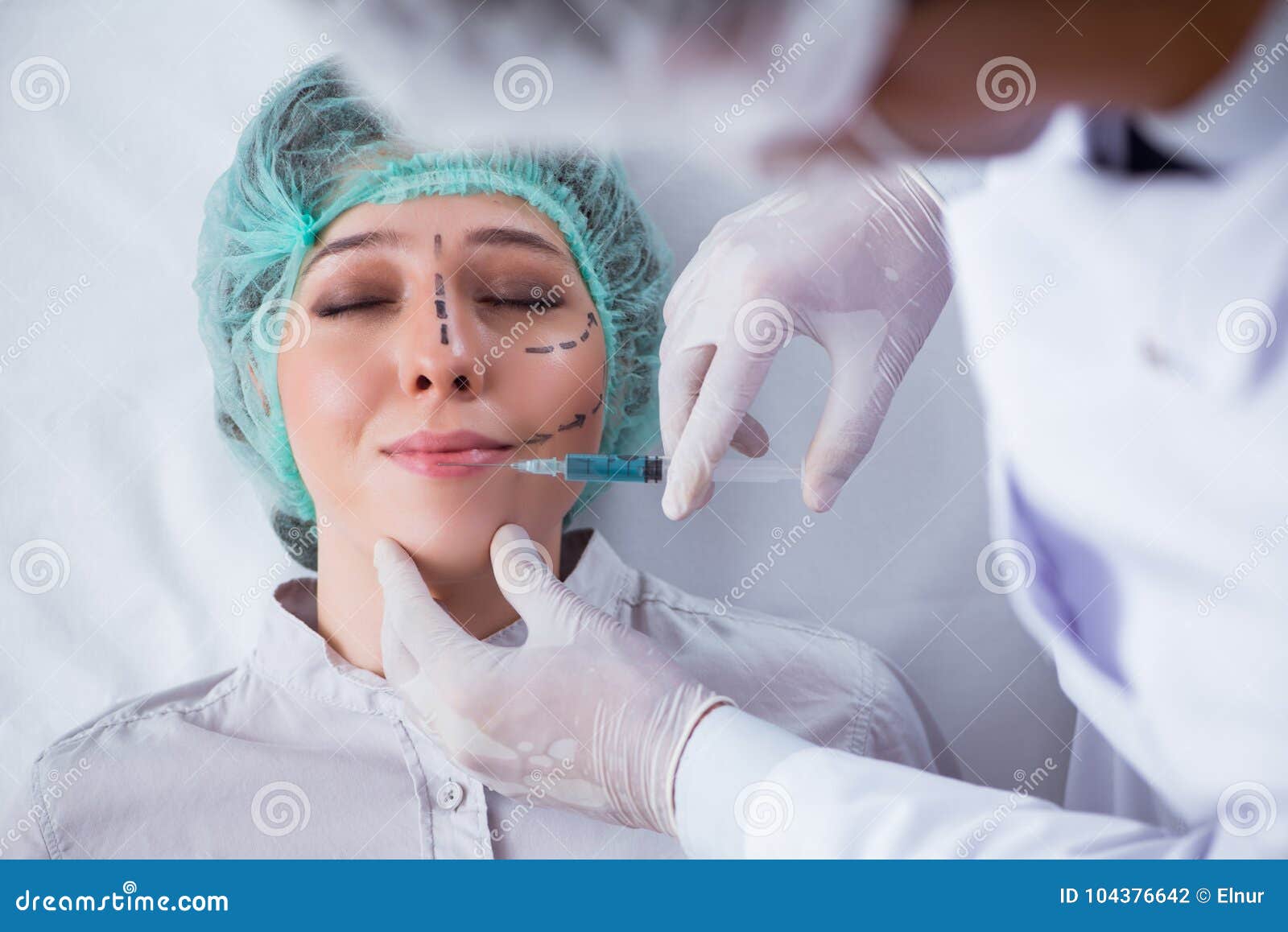 The Plastic Surgeon Preparing for Operation on Woman Face Stock Photo
