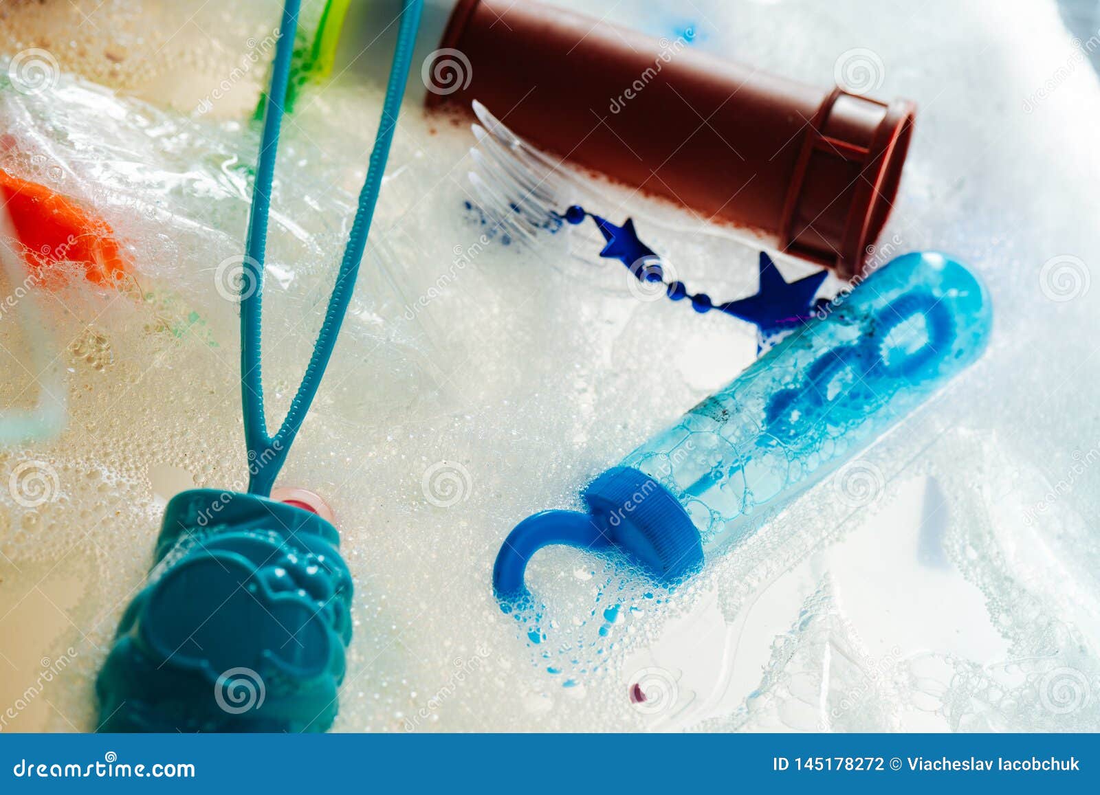 Plastic Toxic Trash and Containers Placed in Bubbled Soapy Liquid Stock