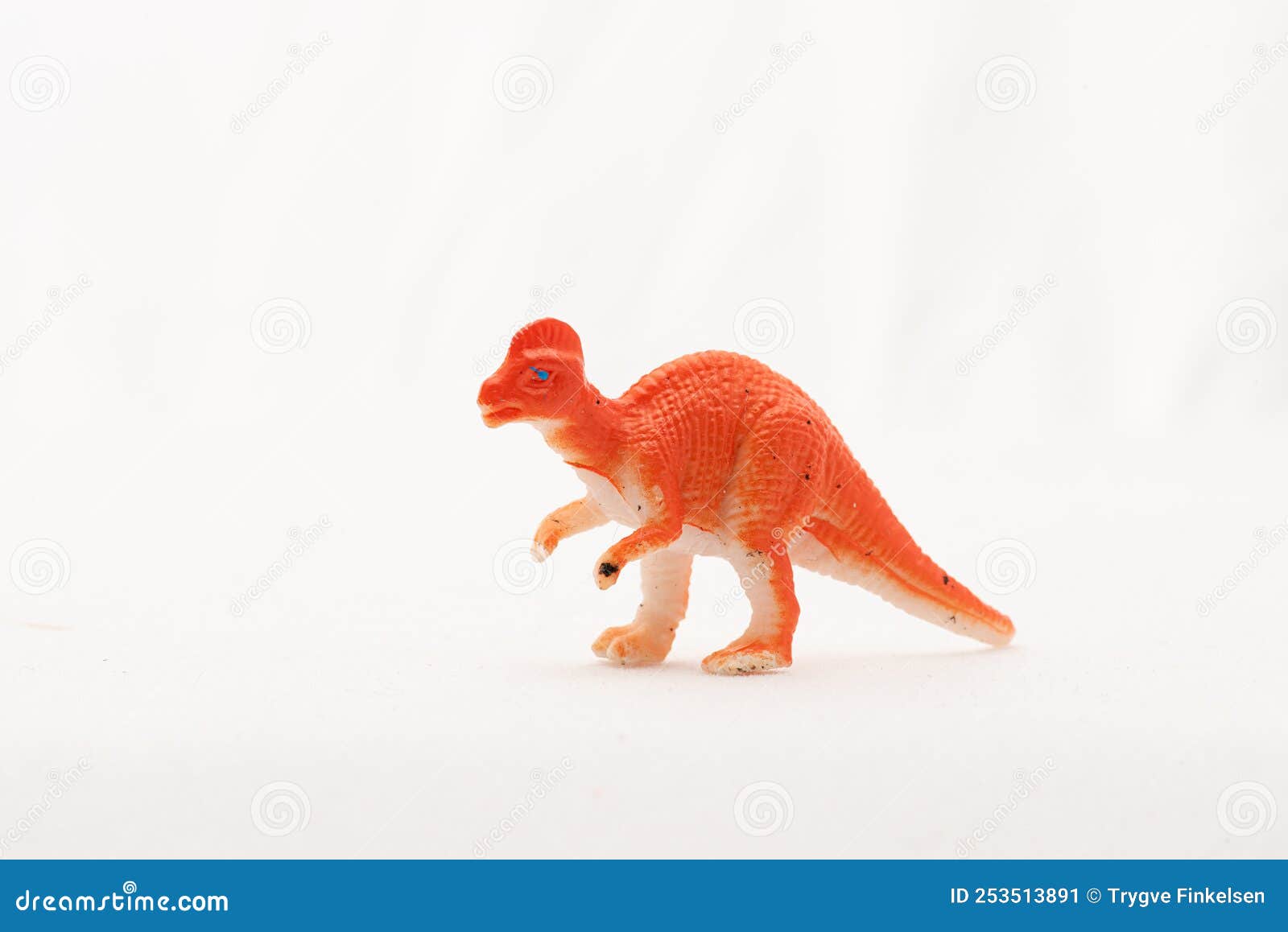 plastic toy corythosaurus dinosaur on white background..