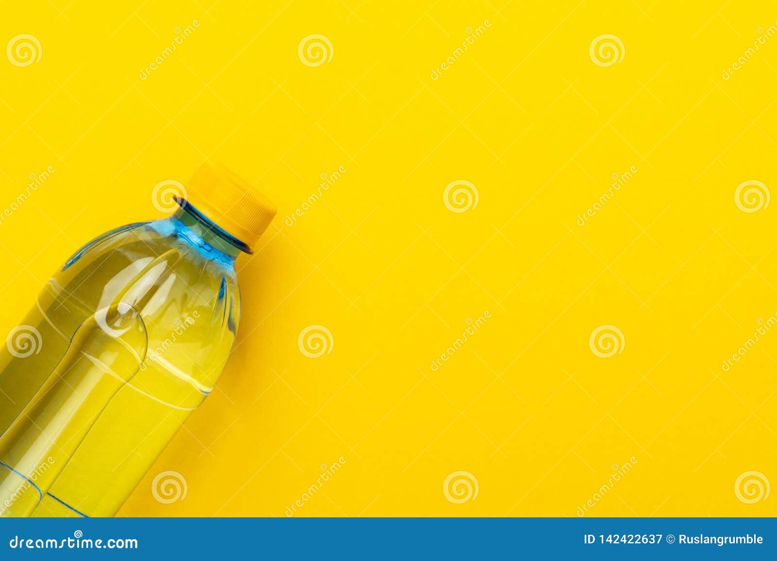 Plastic Bottle of Fresh Water with Yellow Cap on the Yellow Background