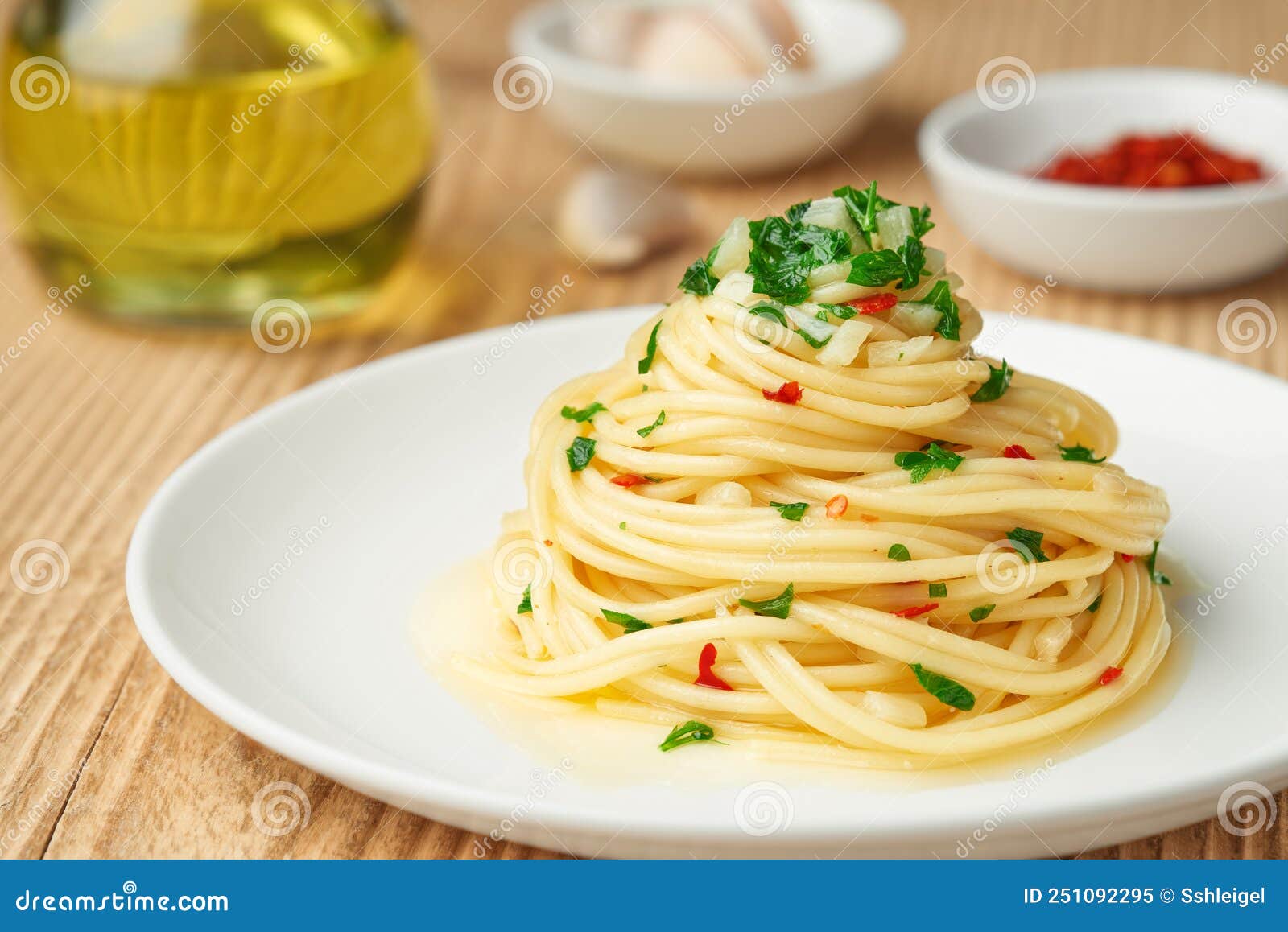 Plate AGLIO E OLIO and Spices on a Wooden Rustic Table Stock Image