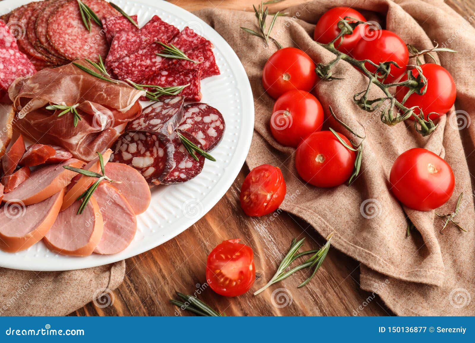 Plate with Assortment of Delicious Deli Meats on Table Stock Image