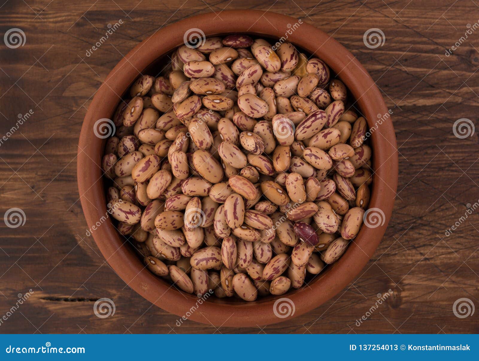 A plate of beans on wooden table background