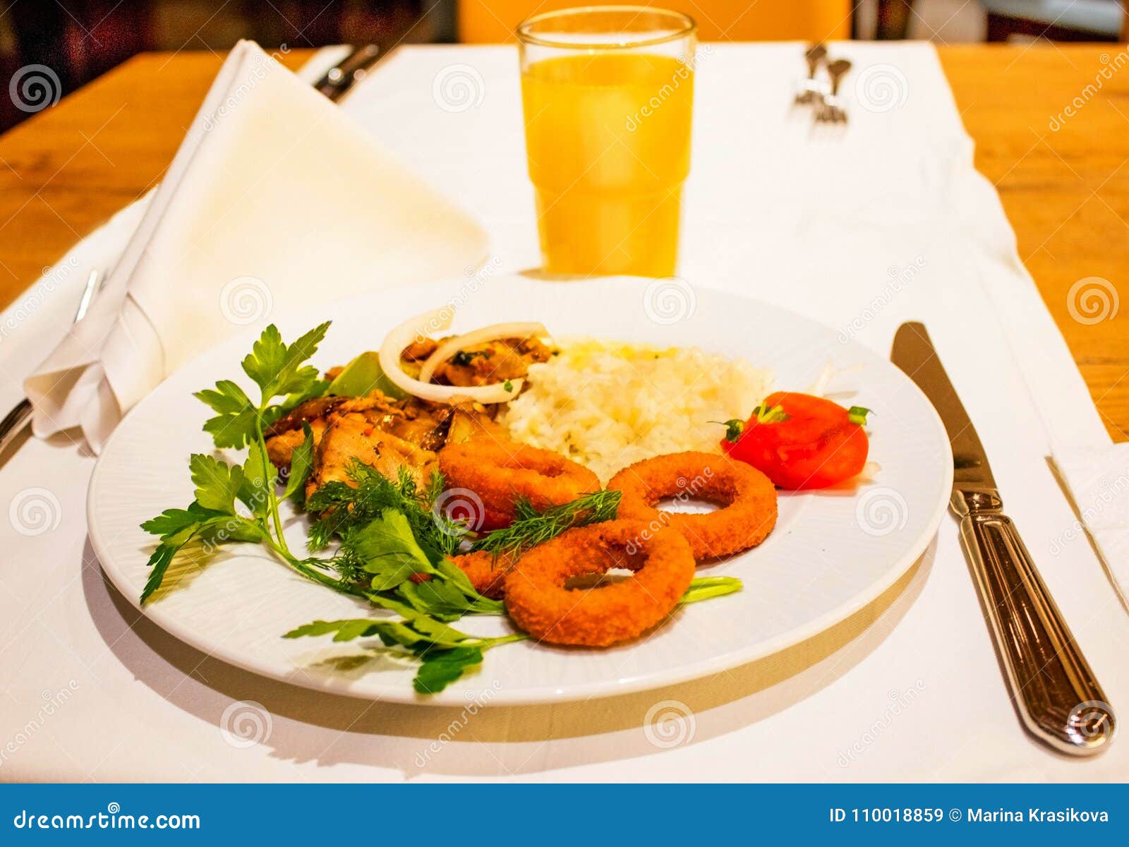 A Plate of Chicken and Rice Side Dish, and Potato Rings Stock Image