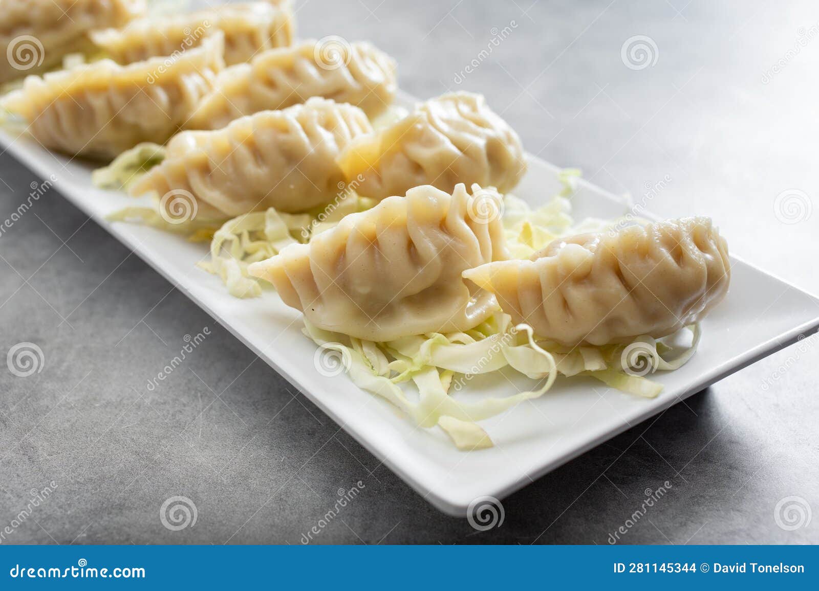 Plate of Chinese Steamed Jiaozi, Dumpling, Potstickers Stock Photo