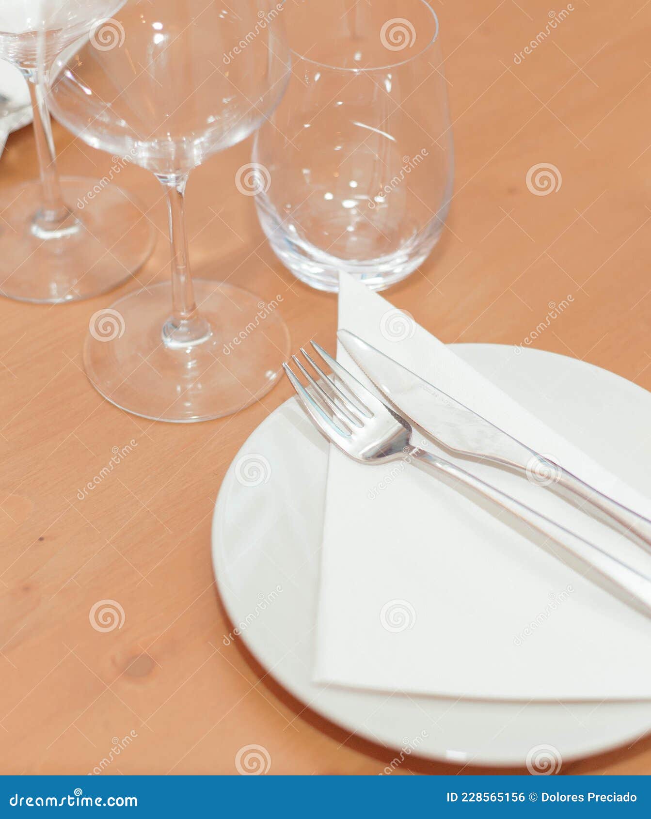 plate, cutlery and glasses set for an elegant dinner