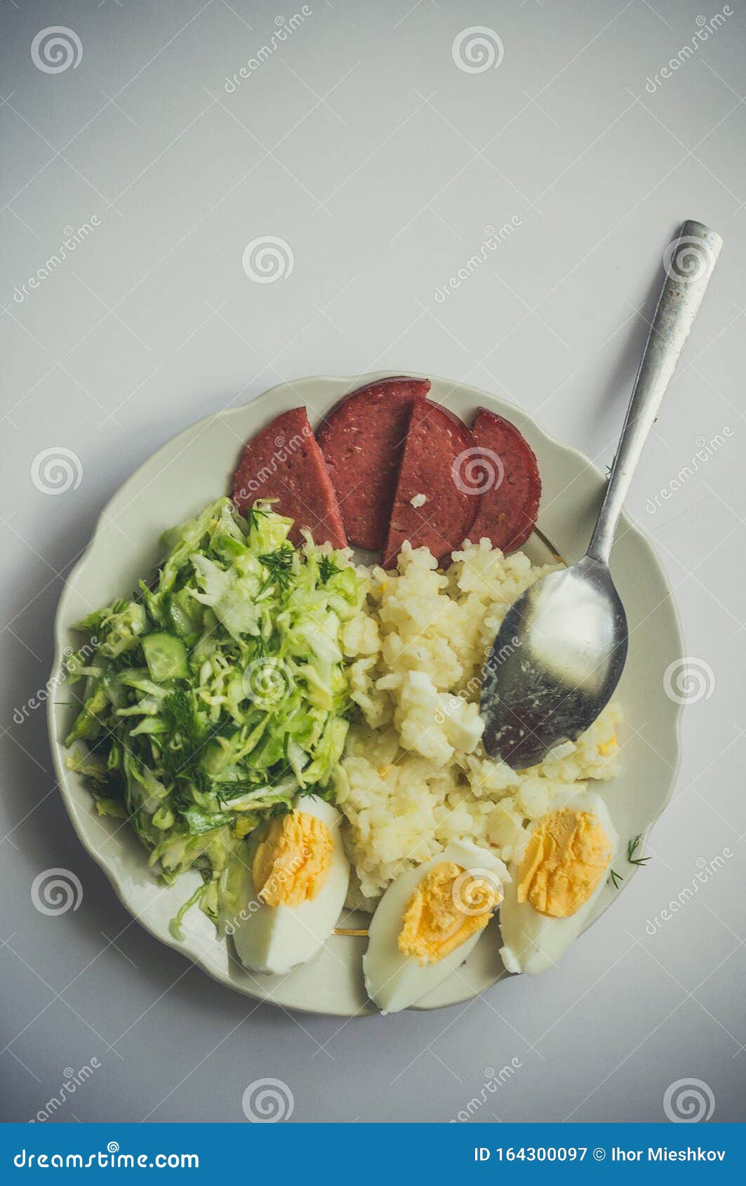 Plate with Delicious Breakfast with Rice, Sausage, Eggs and Salad Stock