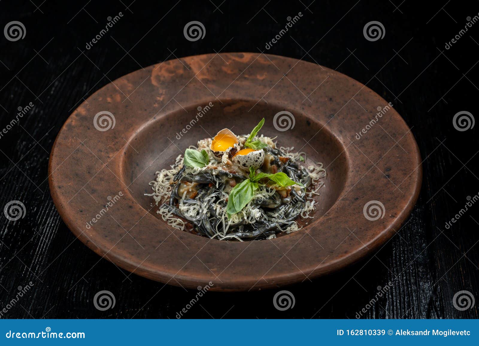 A Plate of Delicious Pasta with Bacon, Cheese and Quail Egg. Stock