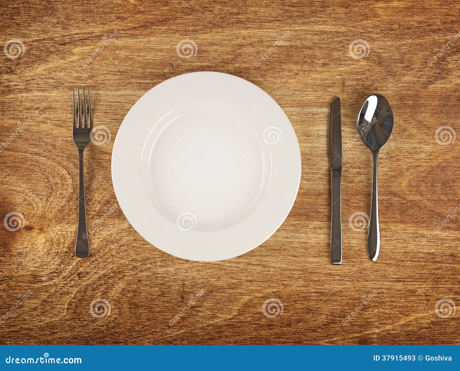 plate and flatware on wooden table