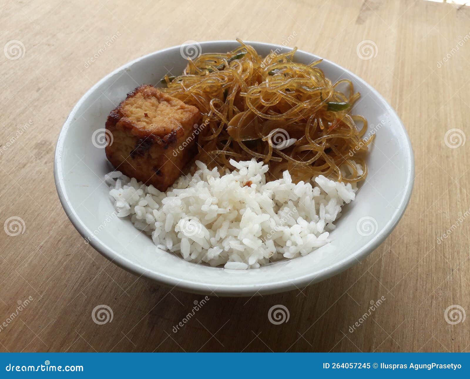 A Plate of Food with White Rice, Tofu, and Stir-fried Noodles Stock