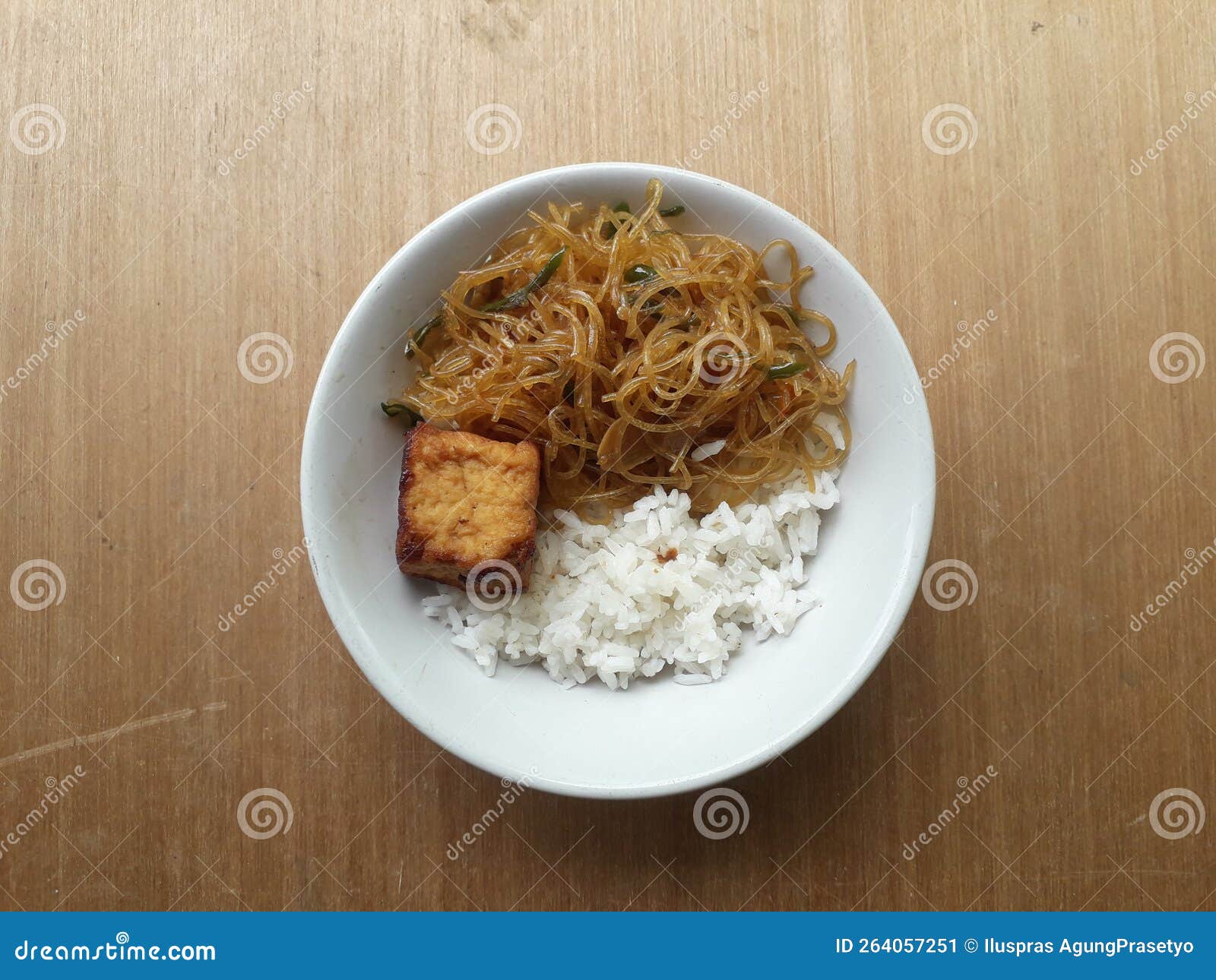 A Plate of Food with White Rice, Tofu, and Stir-fried Noodles Stock