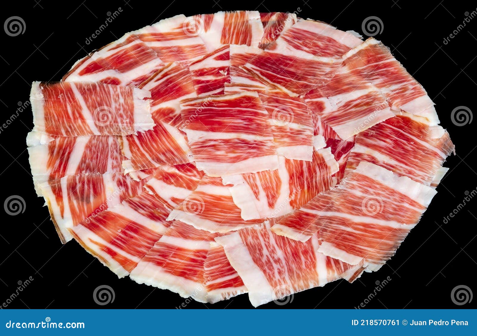 plate of iberian pork ham on black background