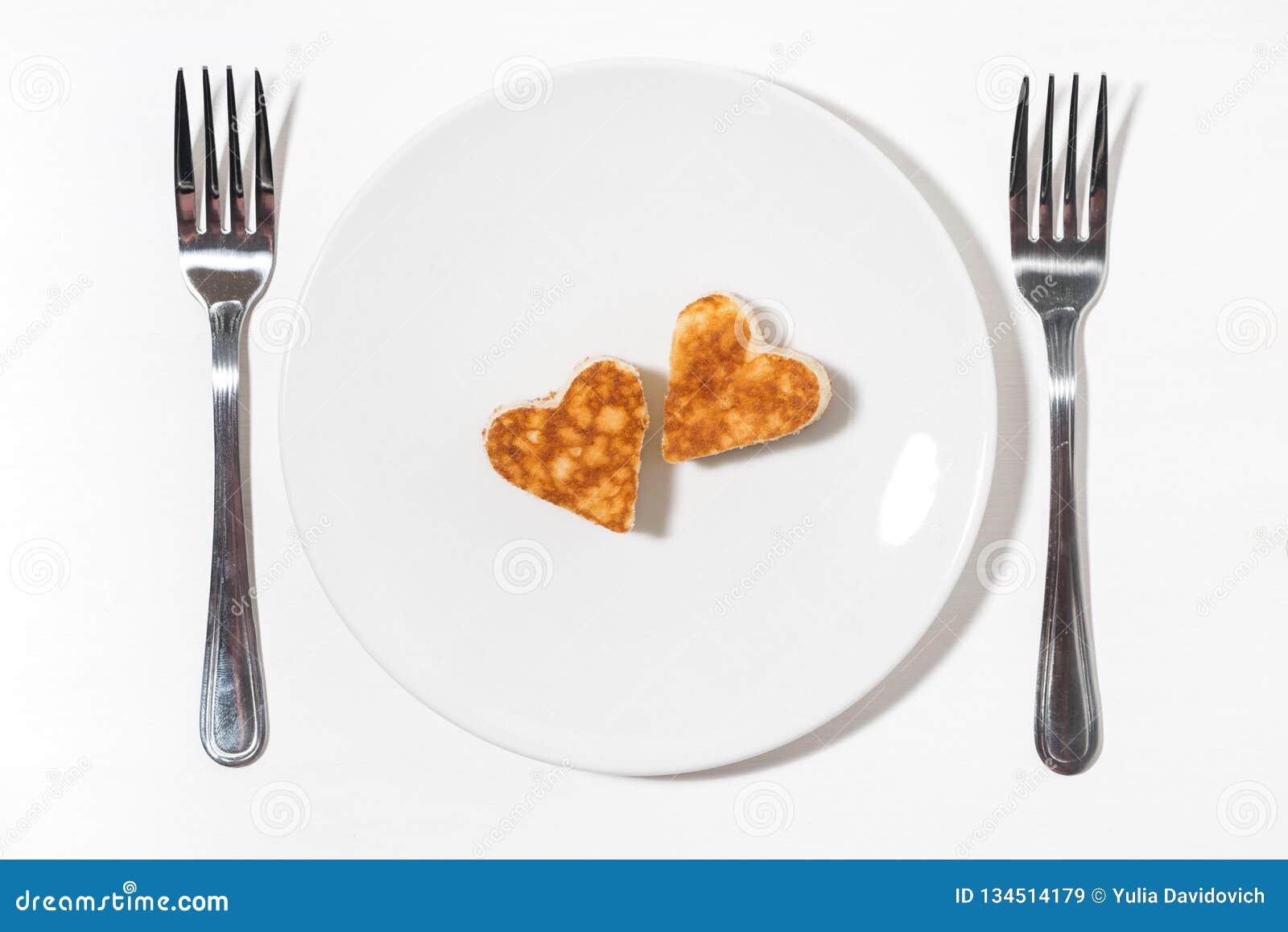 Plate of Pancakes in the Shape of Heart and Two Forks on White ...