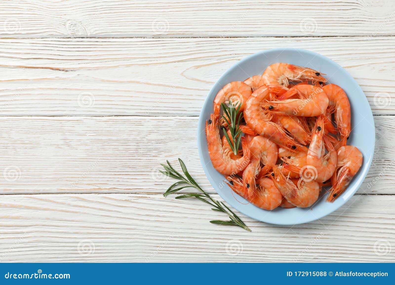 plate with shrimps on background, top view