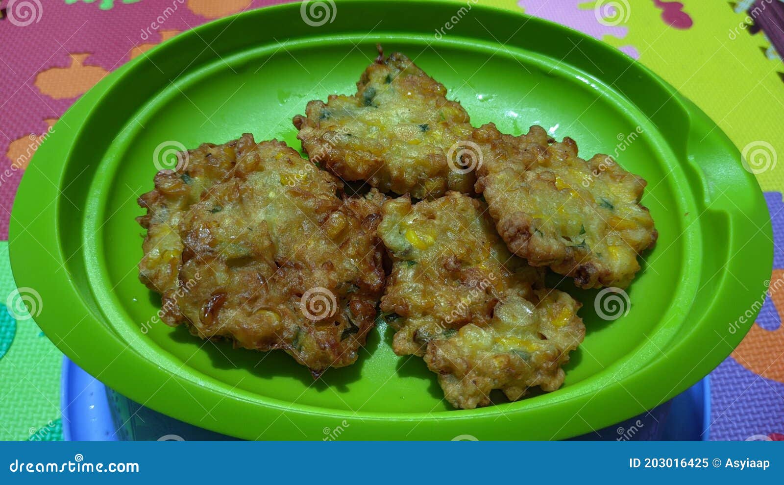 a plate of southeast asian food corncakes called perkedel jagung