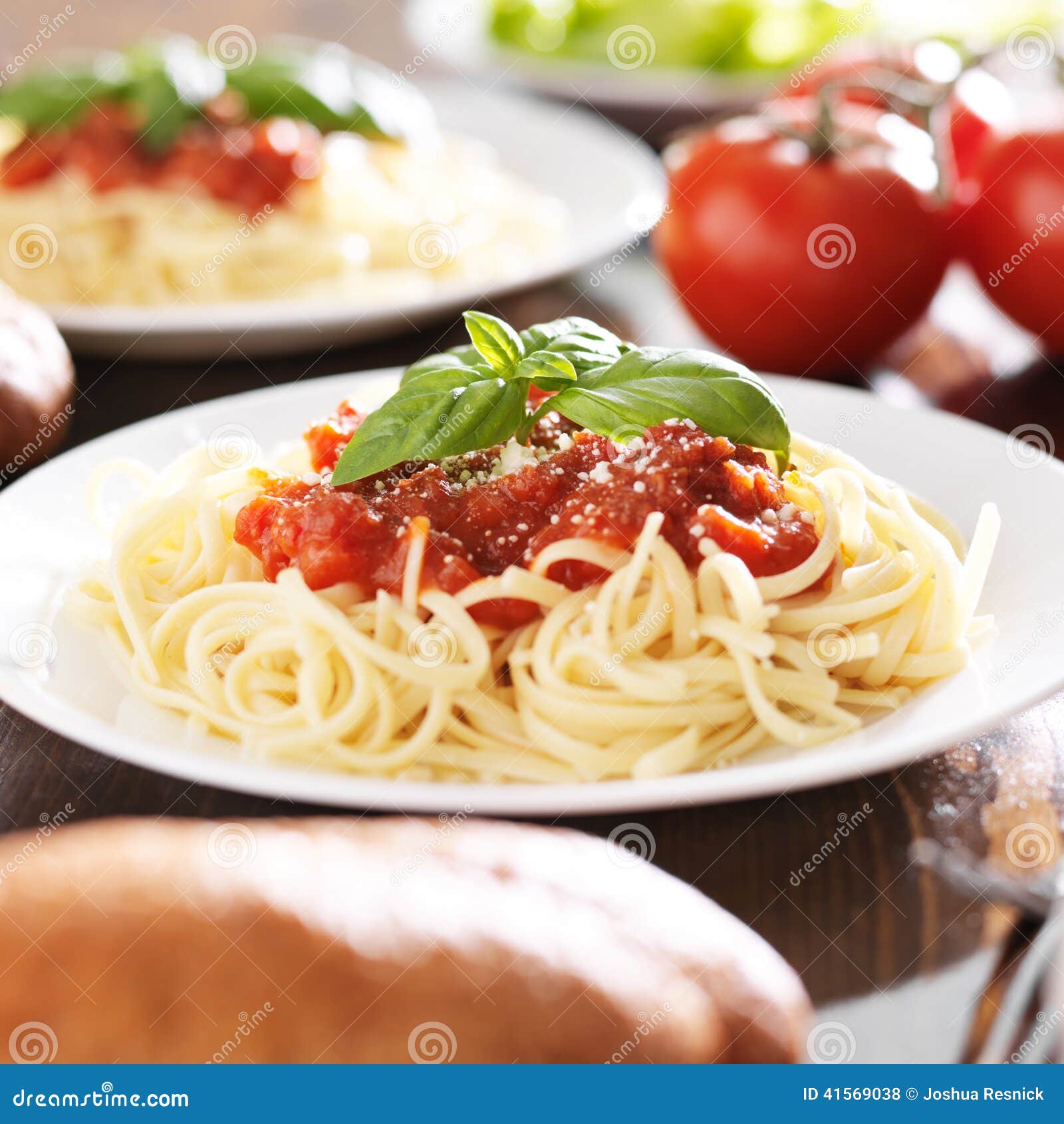 Plate of Spaghetti with Basil Garnish. Stock Photo Image of garnish