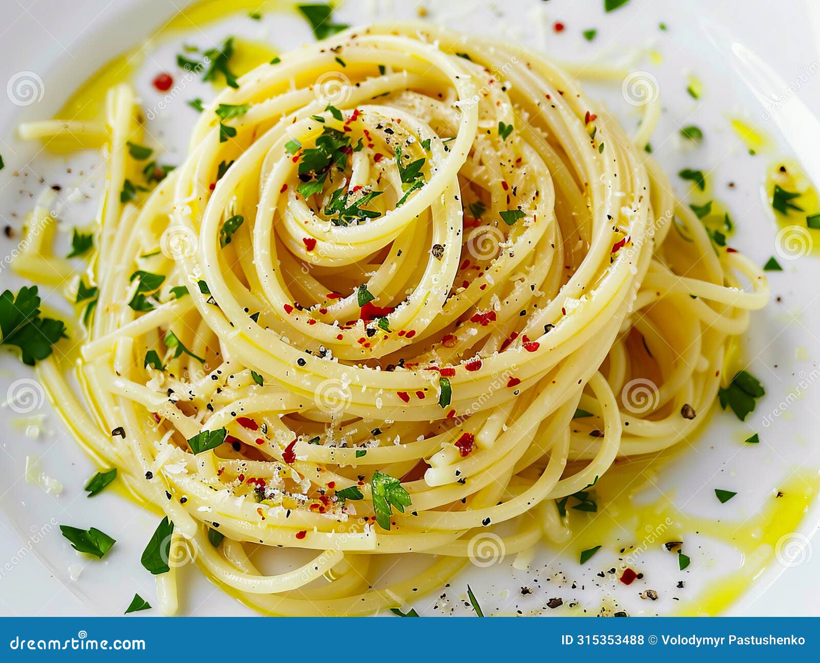 a plate of spaghetti with parsley and herbs