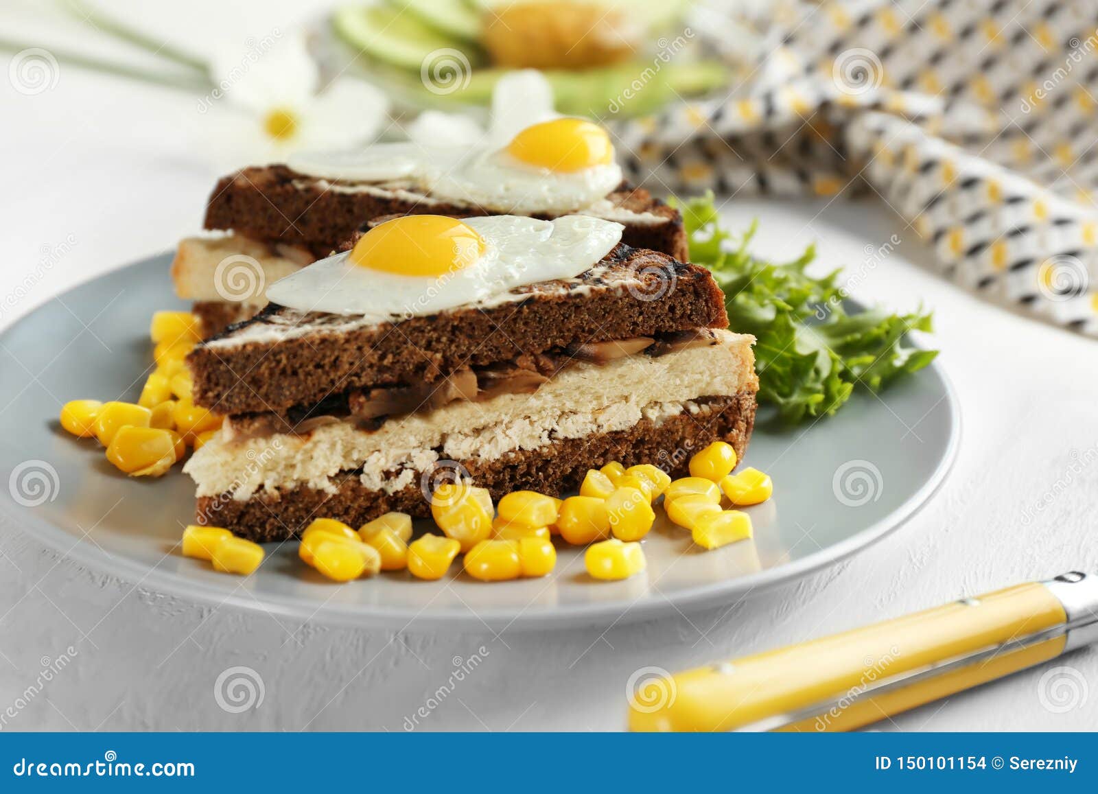 Plate with Toasted Bread, Fried Eggs and Corn Kernels on Table Stock