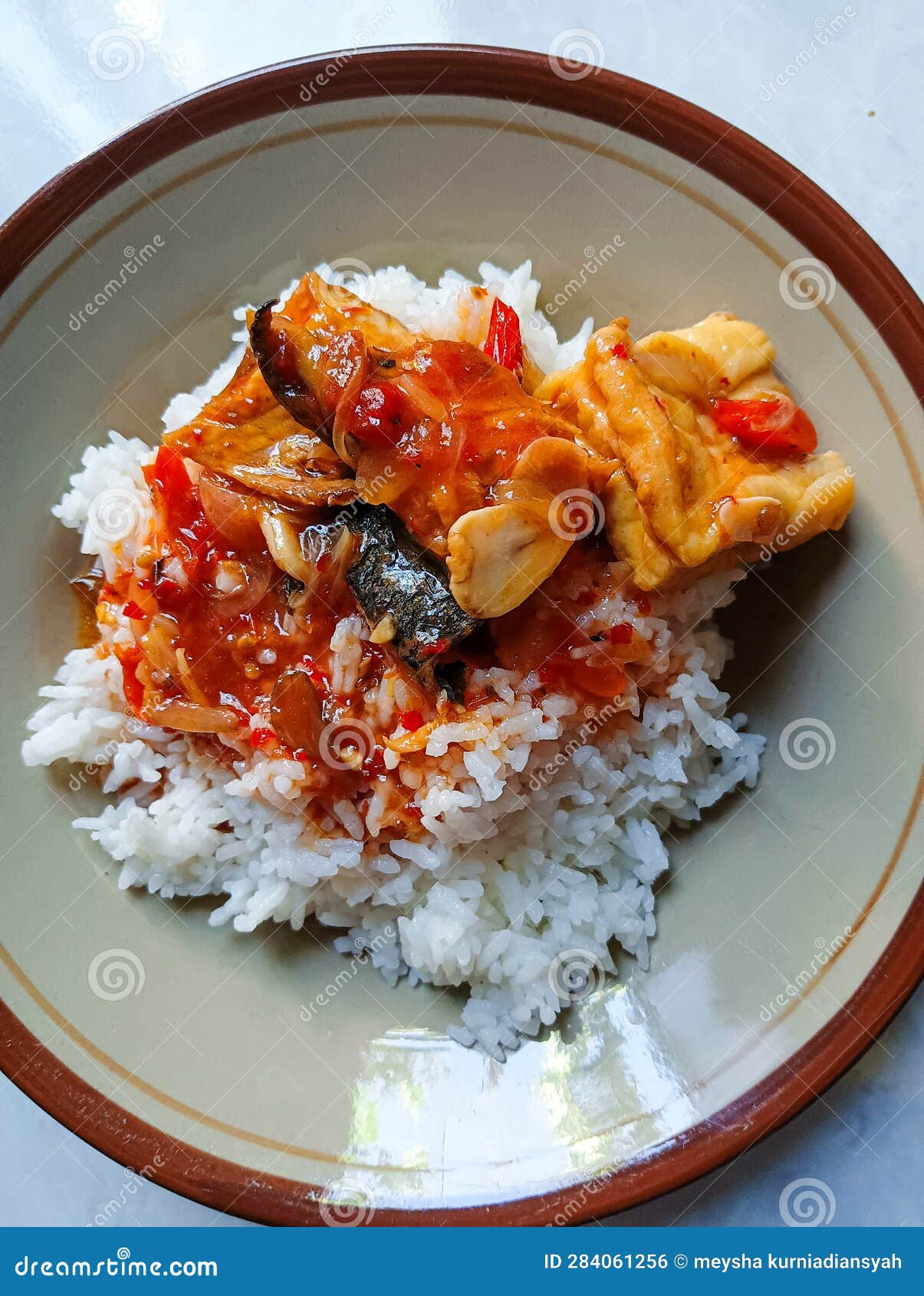 A Plate of Warm Rice with Stirfried Fish with Red Spices Stock Photo