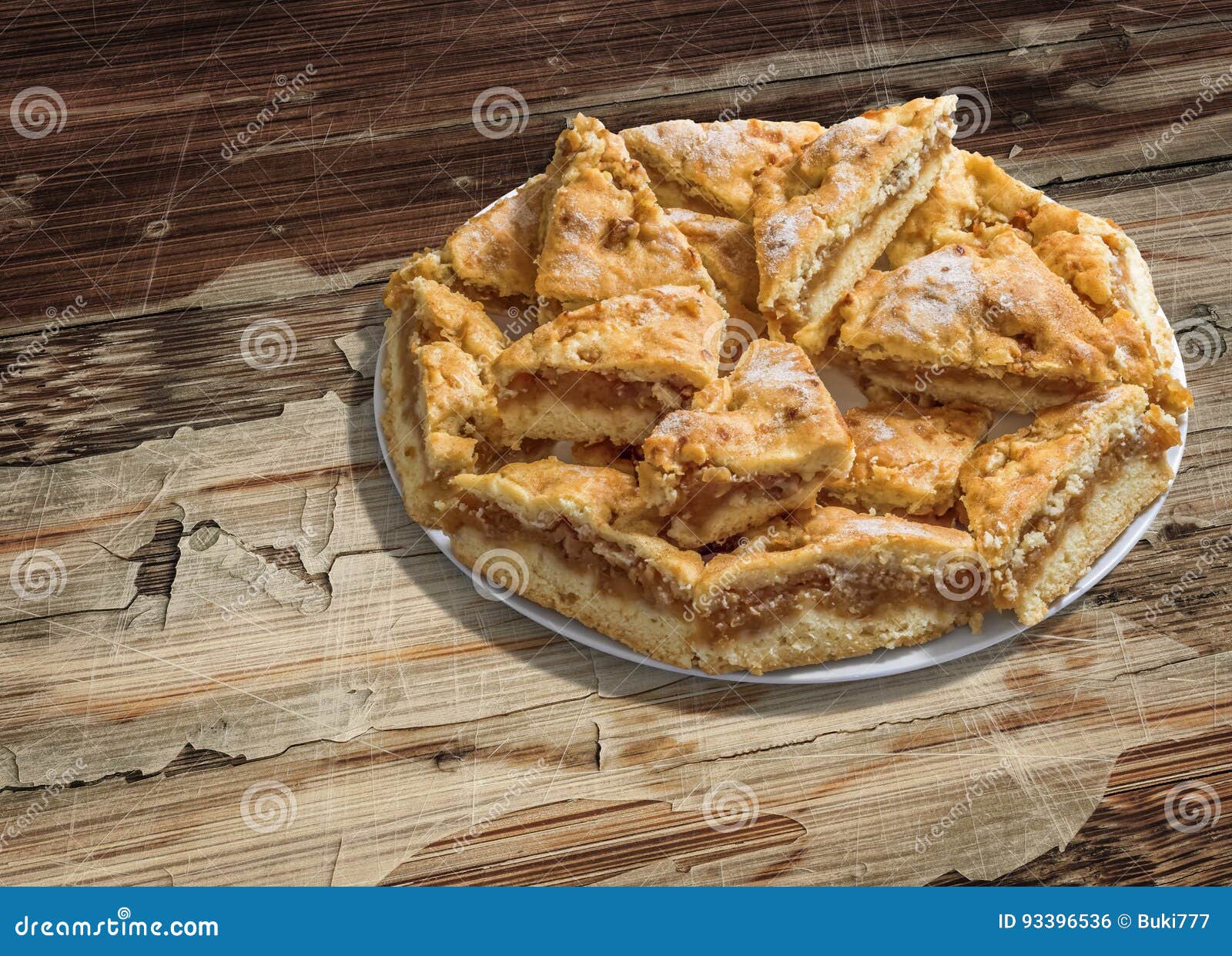 plateful of lazy apple pie slices set on old cracked flaky wooden garden table