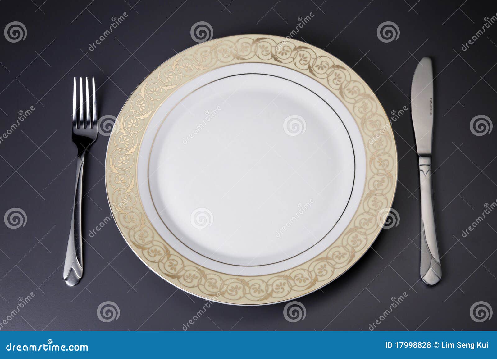 Plates and cutlery stock photo. Image of knife, gold 17998828