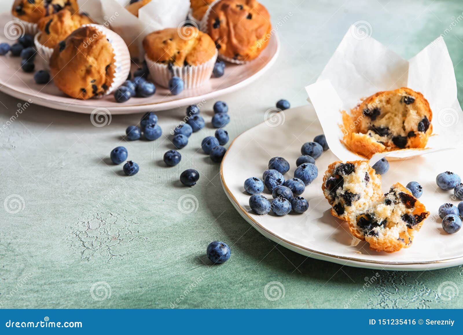 Plates with Tasty Blueberry Muffins on Color Table Stock Photo - Image ...