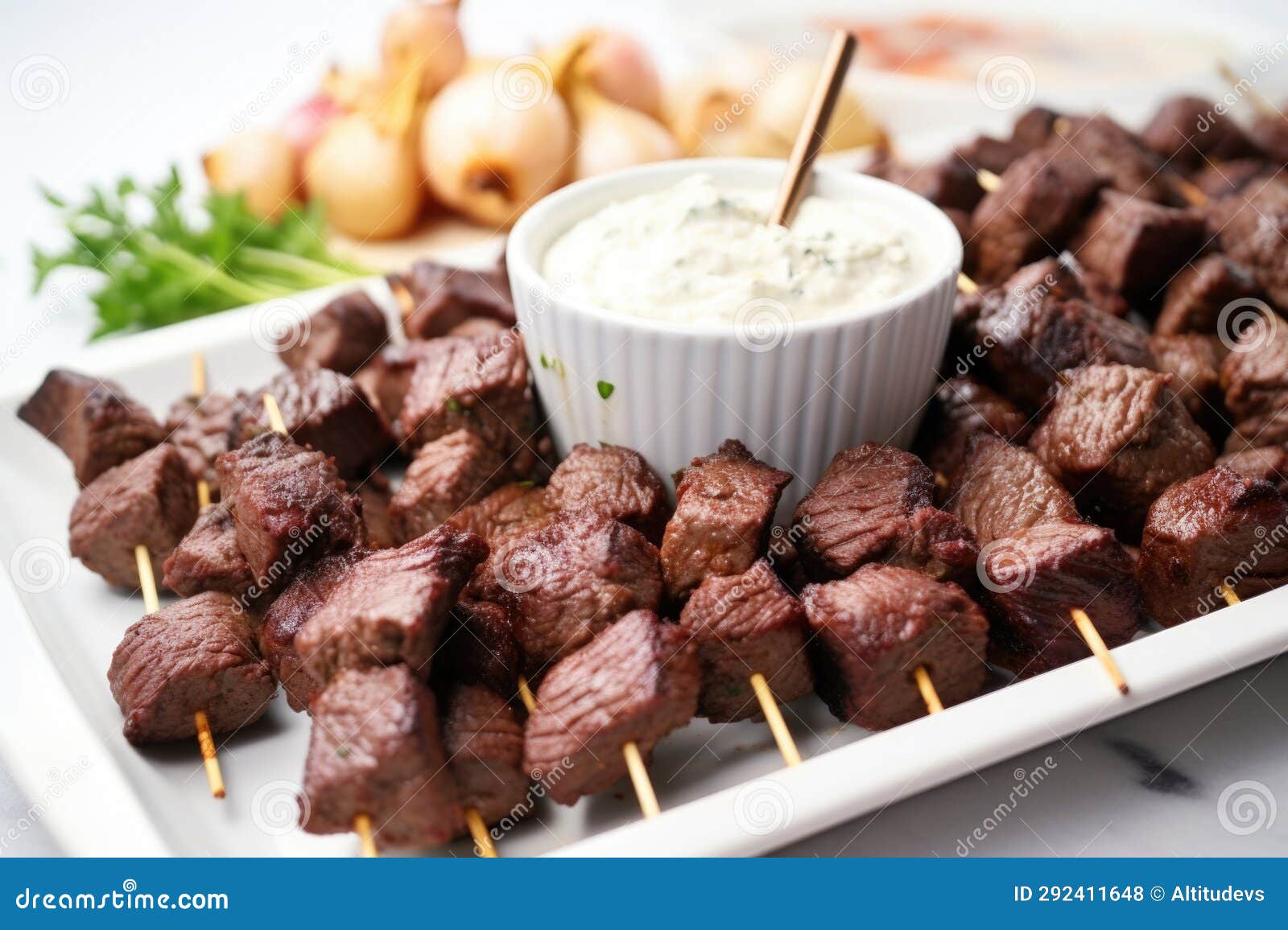 Platter of Cooked Steak Tips with Roasted Garlic Spread Stock Photo