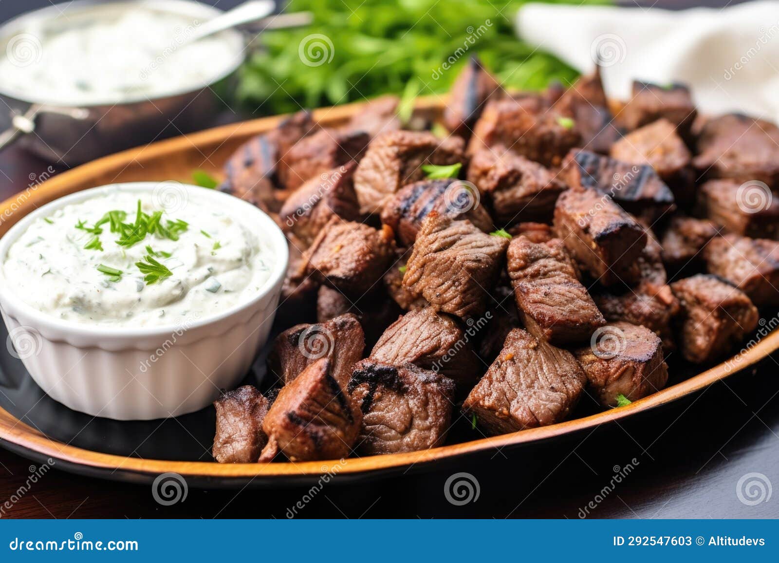 Platter of Cooked Steak Tips with Roasted Garlic Spread Stock