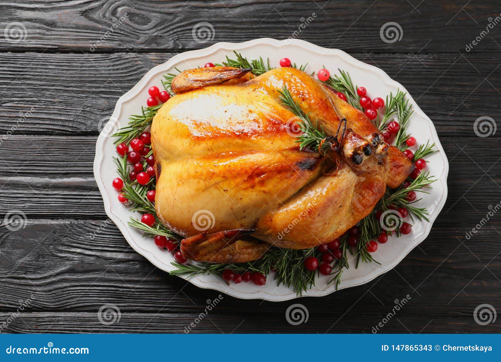 Platter Of Cooked Turkey With Garnish On Wooden Background Stock Image
