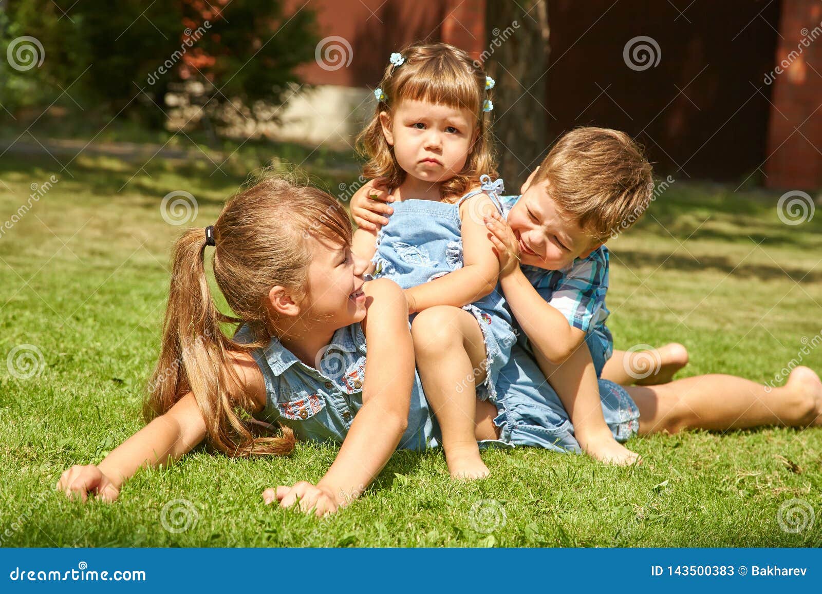 Playful Children Outdoors in the Summer on the Grass in a Backyard