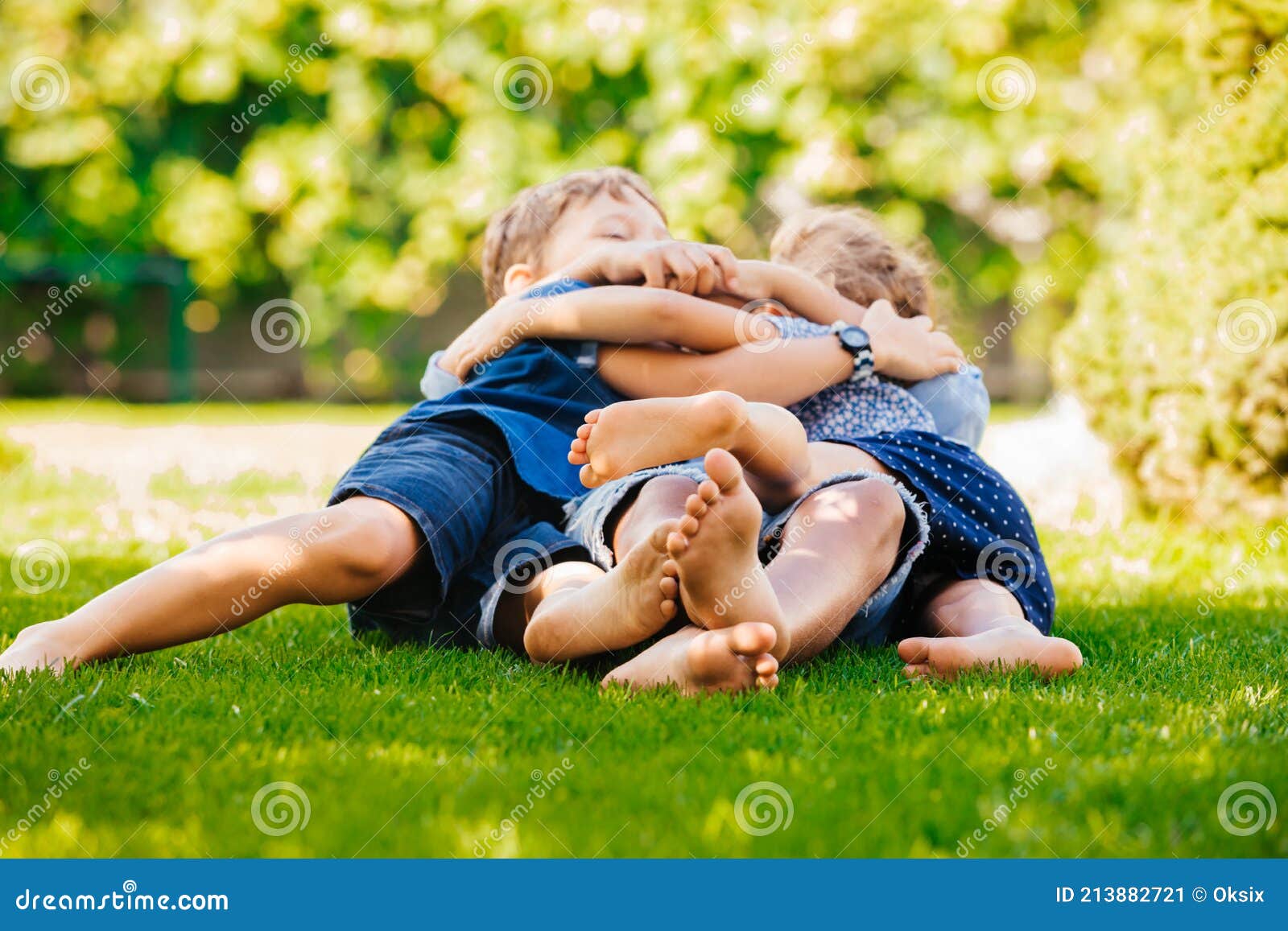 Playful Siblings Having Fun On A Green Lawn Stock Image Image Of