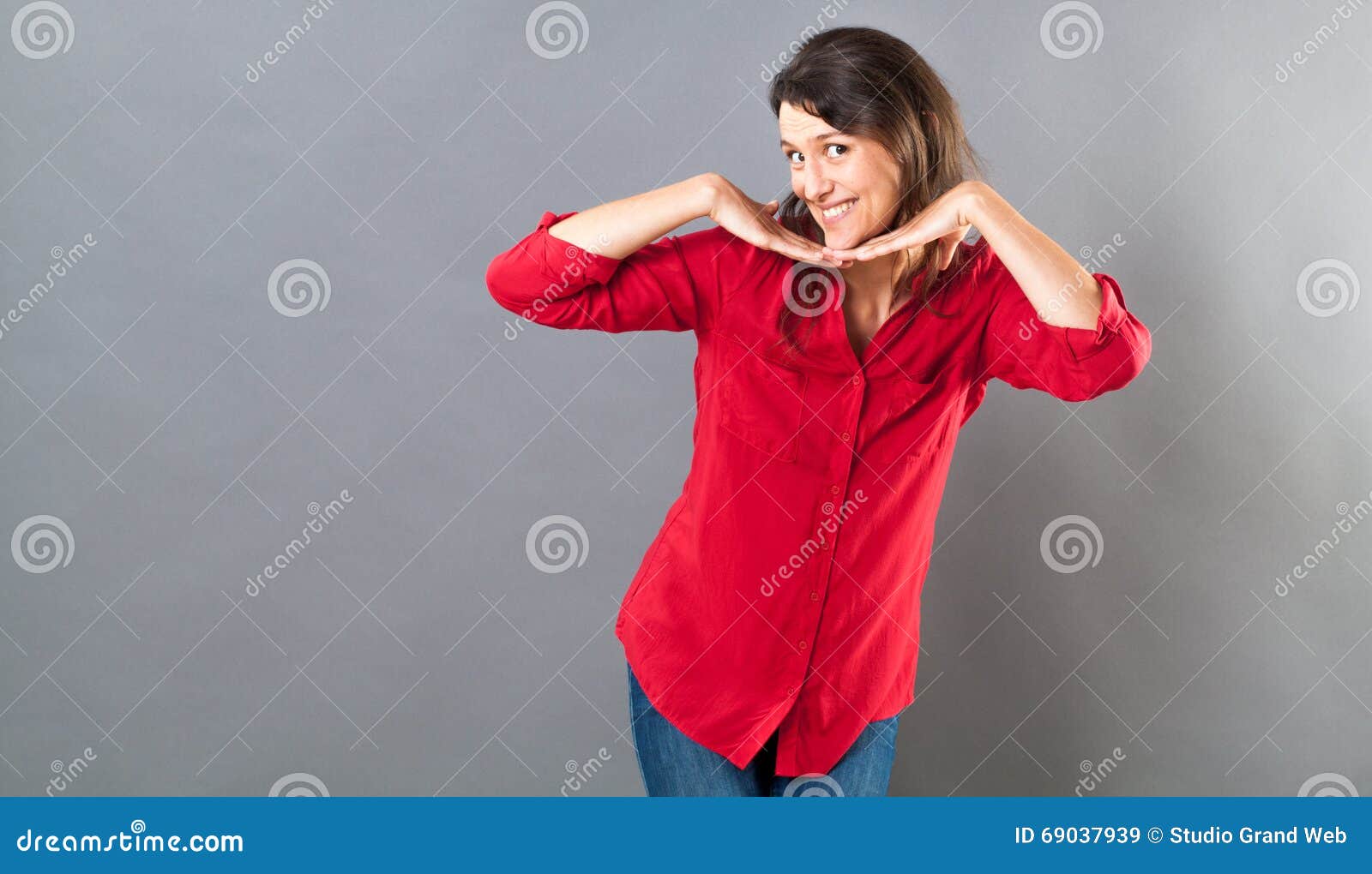 playful woman posing with fun hand gesture for seduction