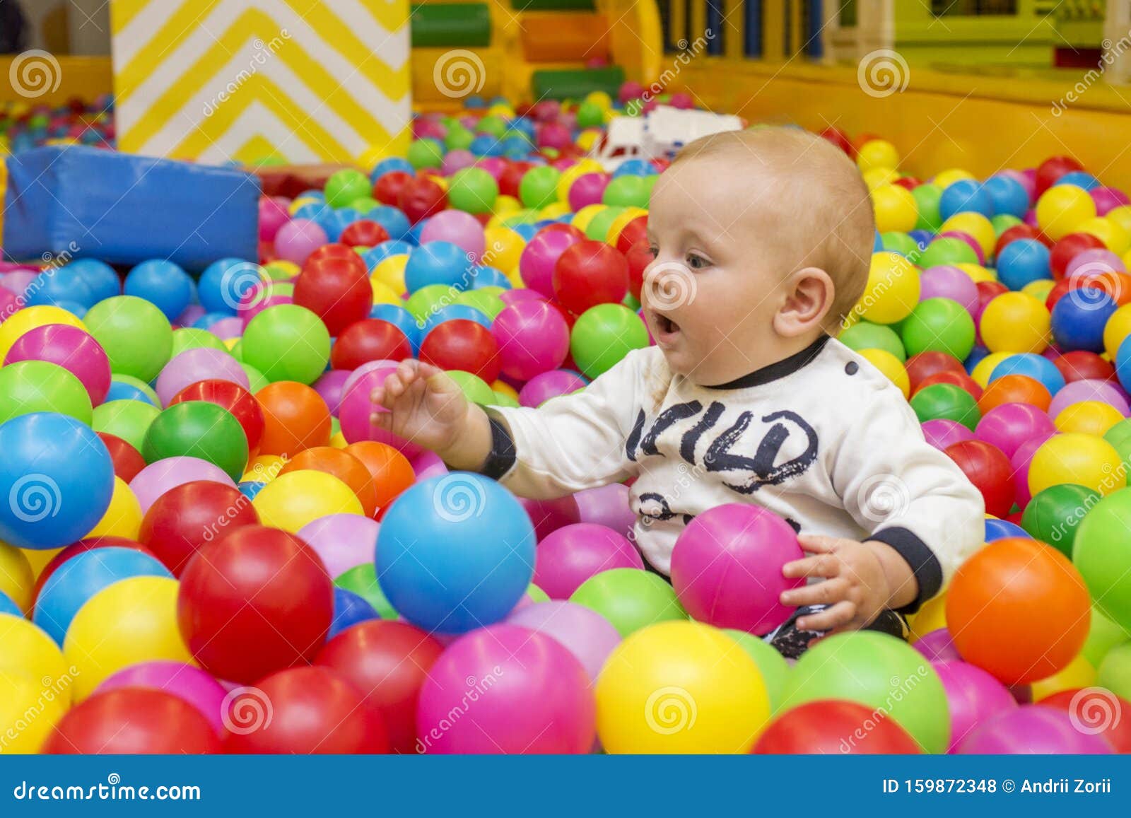 Playground with Ball Pit Indoor. Joyful Small Kid Having Fun at Indoor