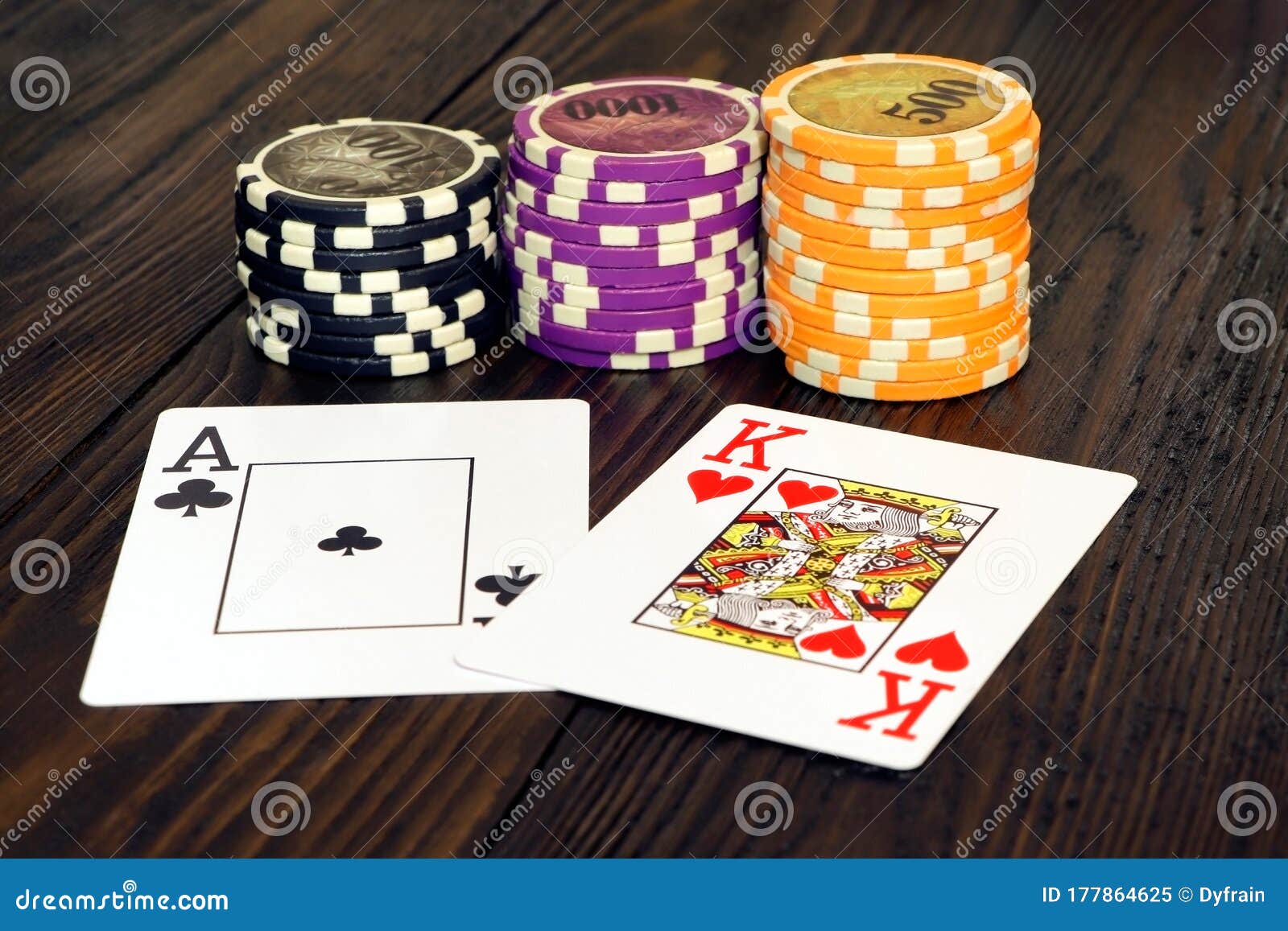 Playing Cards and Poker Chips on a Wooden Table. Stack of Chips for