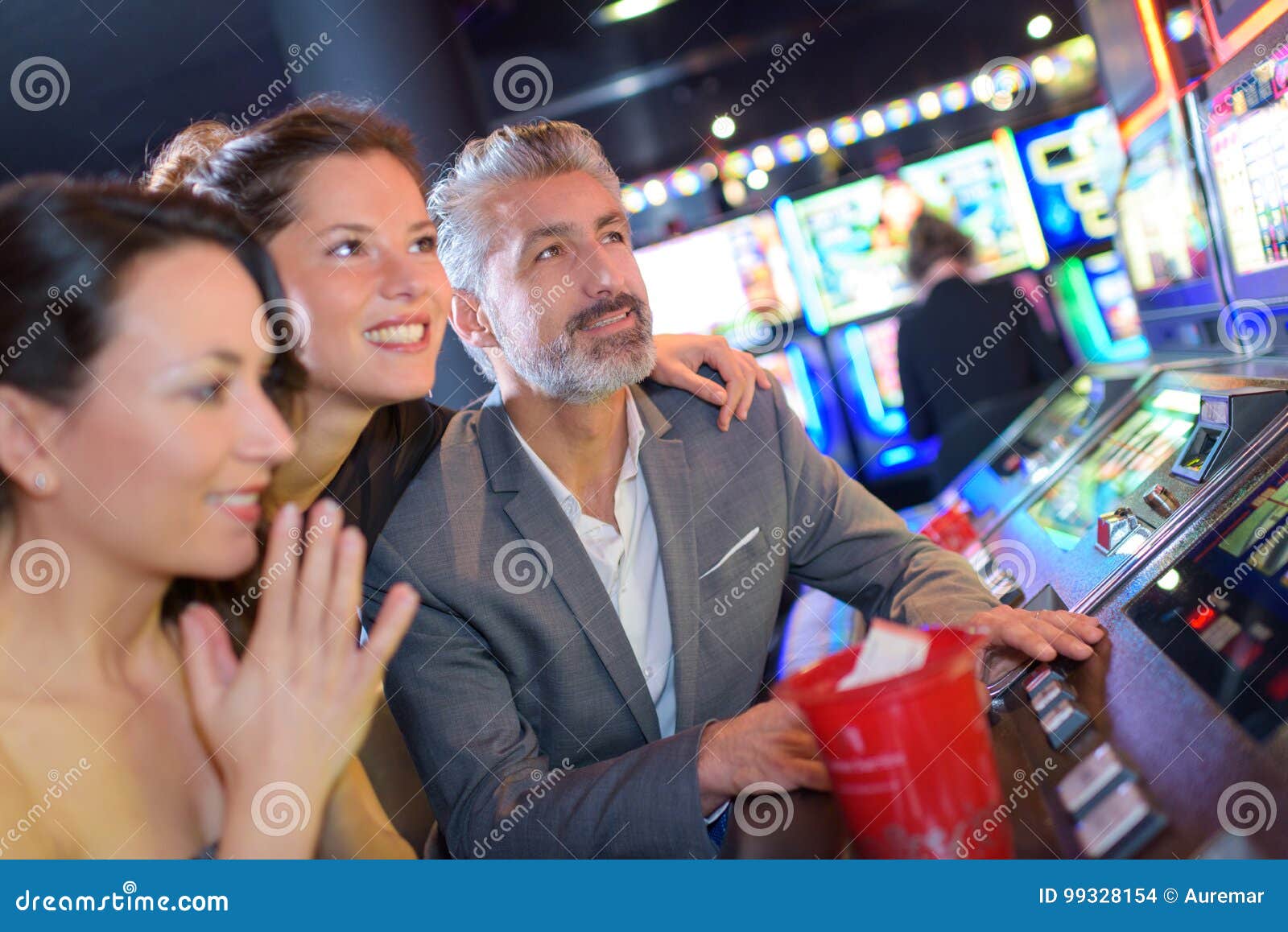 playing slot machines at casino with girls