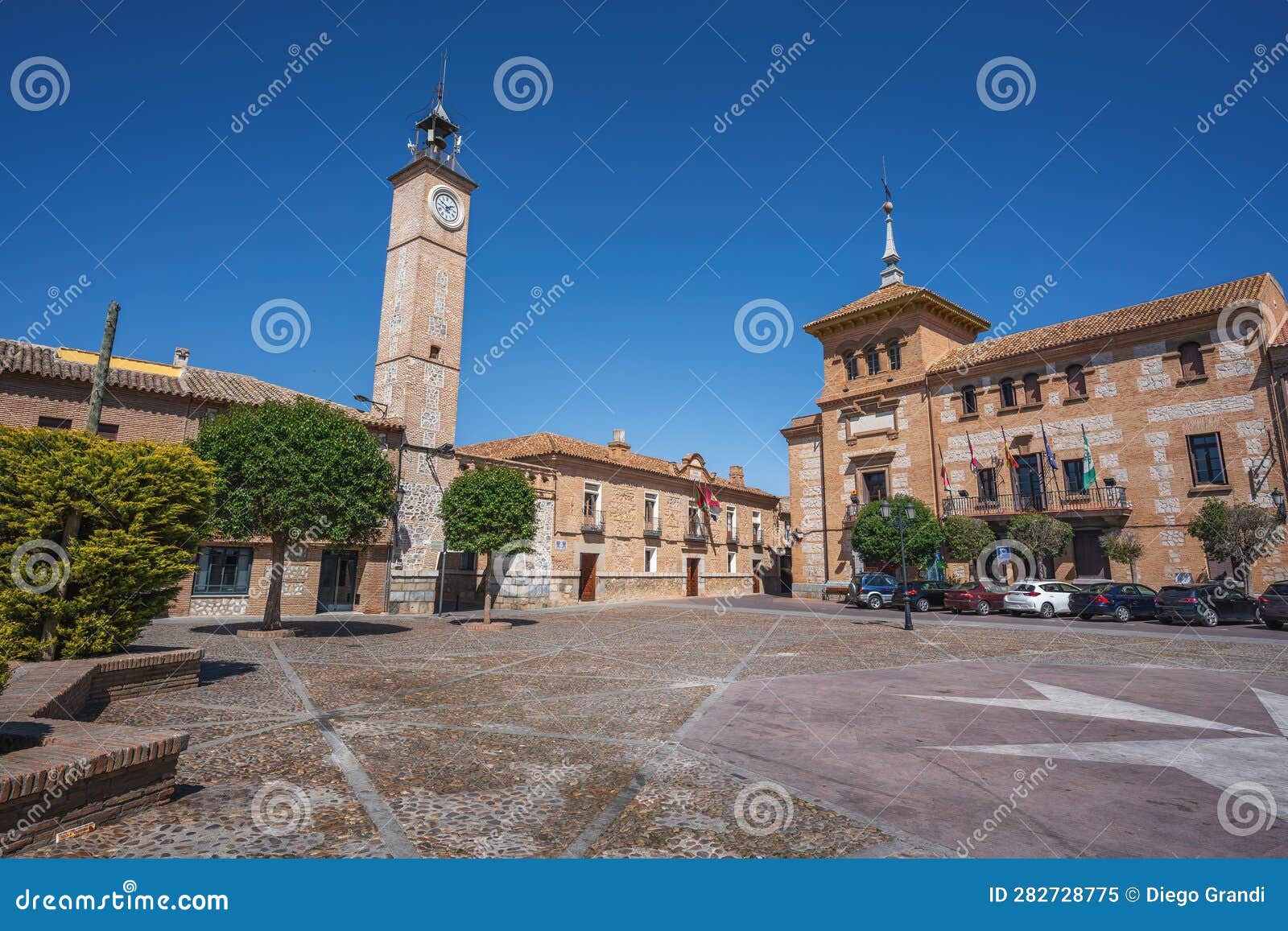 plaza de espana square with clock tower and consuegra city hall - consuegra, castilla-la mancha, spain