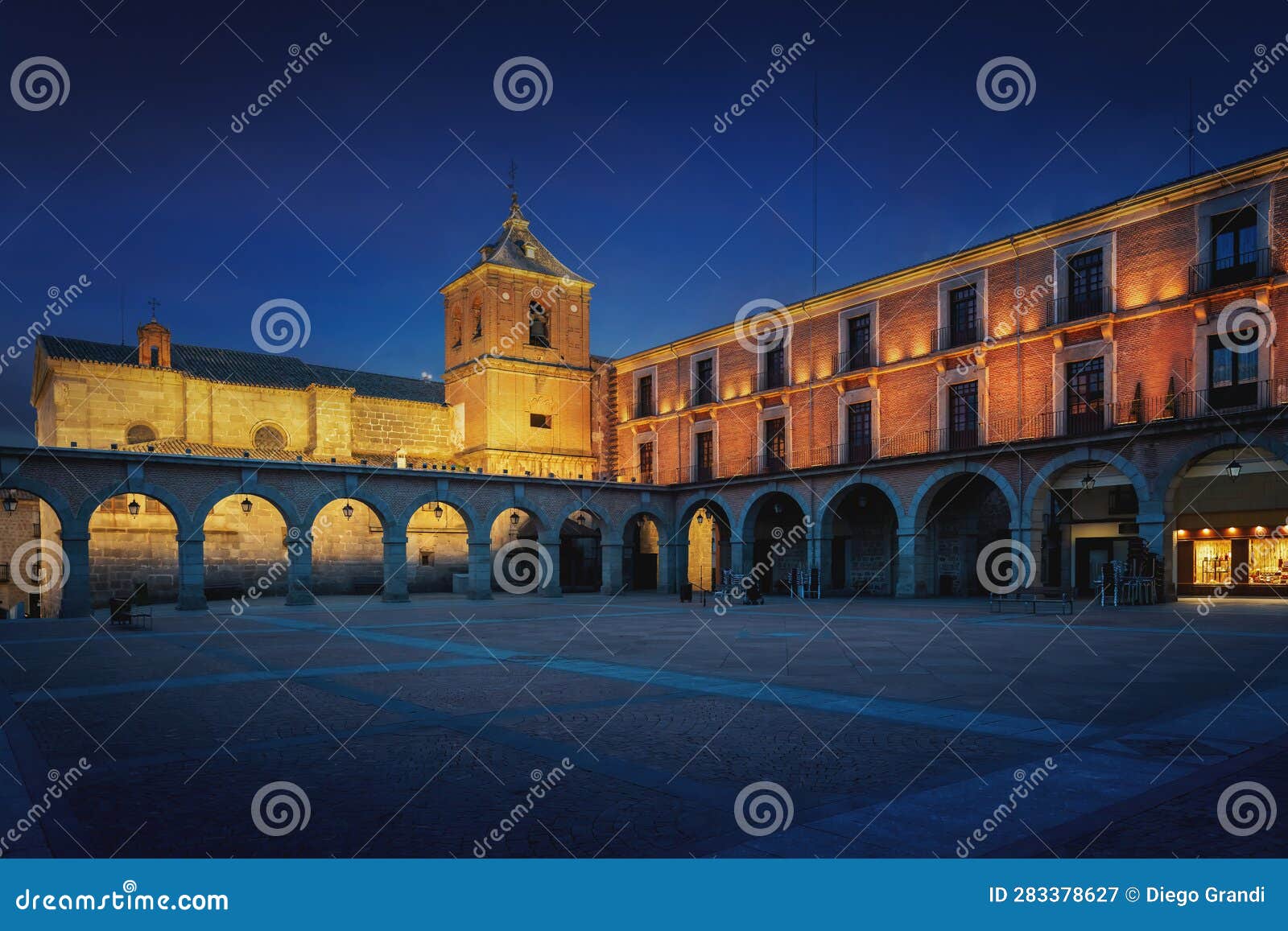 plaza del mercado chico square with church of saint john baptist (san juan bautista) at night - avila, spain