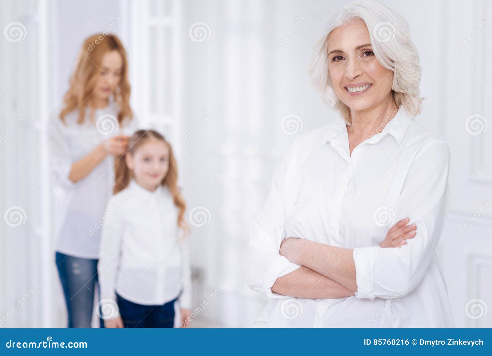 pleasant cheerful senior woman resting with her family at home