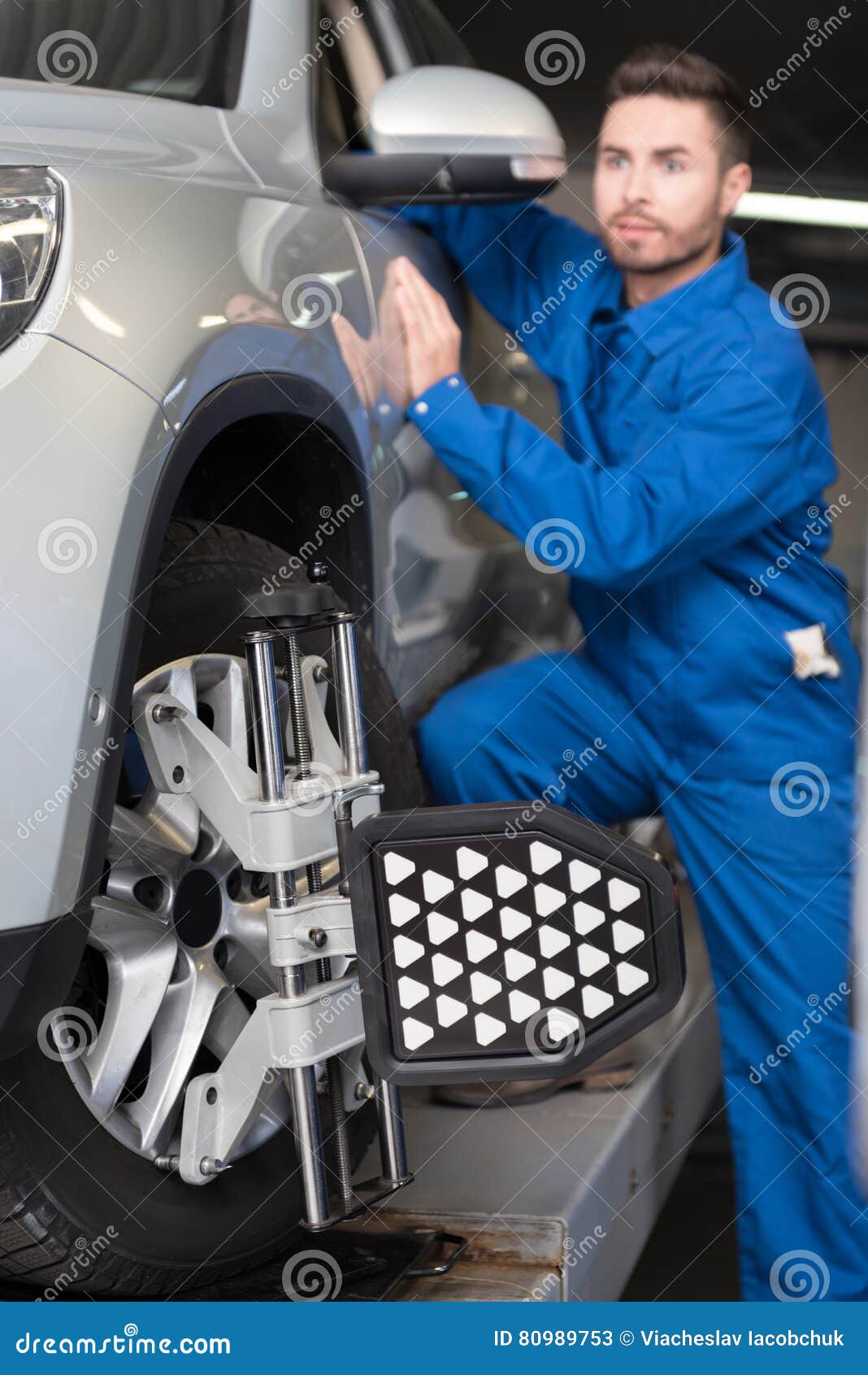 Pleasant Mechanic Adjusting Automobile Wheel Alignment Stock Image