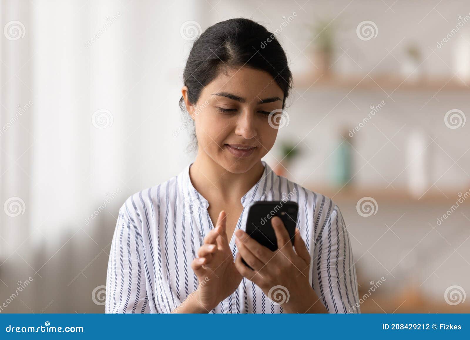 Side View Pleasant Millennial Mixed Race Woman Holding Smartphone